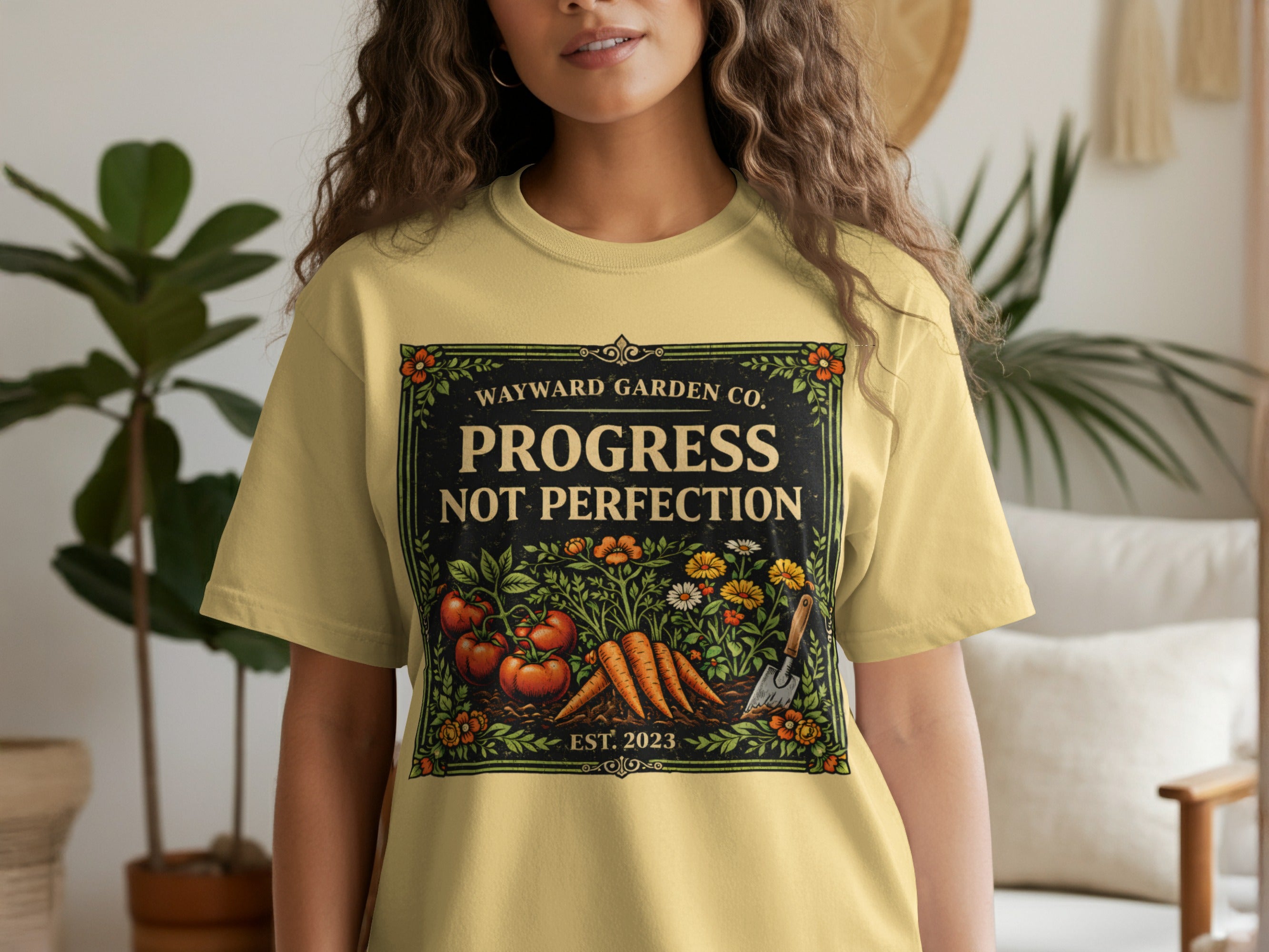 Yellow t-shirt with garden design: "Progress Not Perfection."