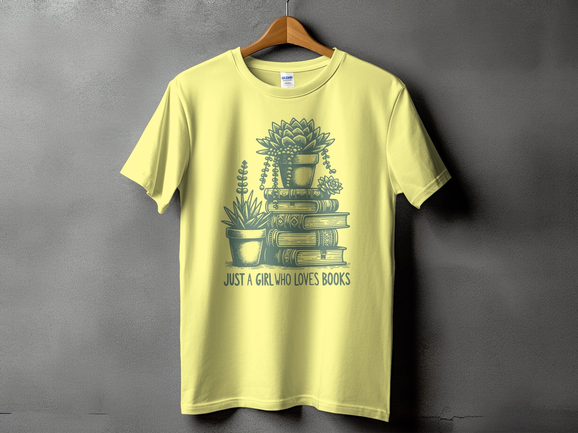 Light yellow t-shirt with a stack of books and succulents. "JUST A GIRL WHO LOVES BOOKS" text.