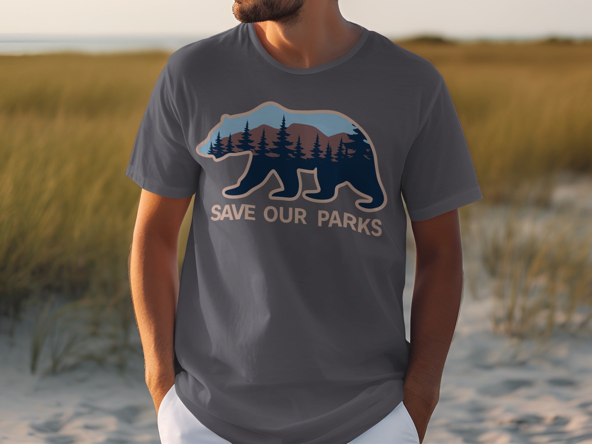 Dark grey t-shirt with a bear graphic containing a forest and mountains, and text "SAVE OUR PARKS".