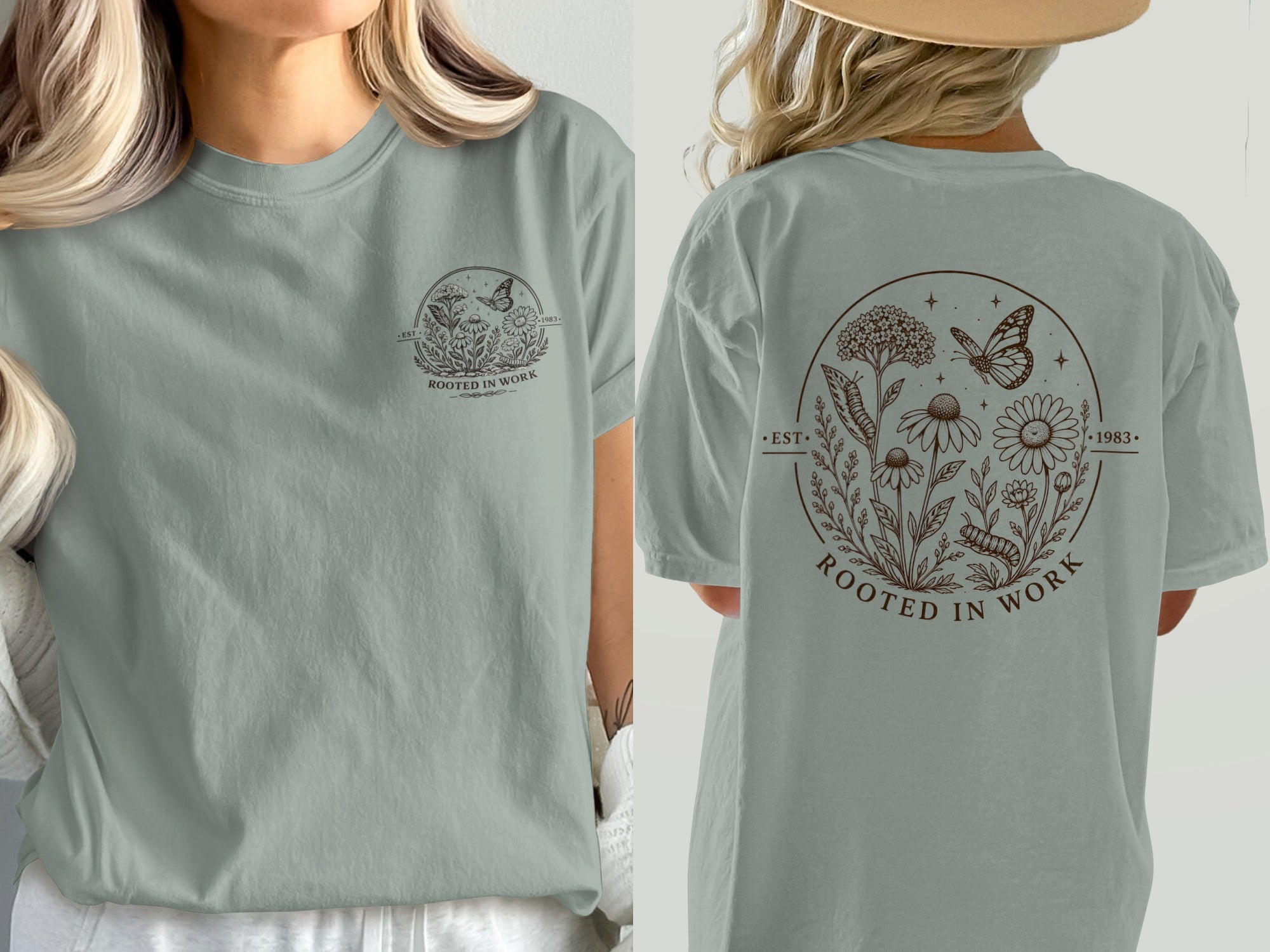 Gray t-shirt with a circular nature graphic including flowers, a butterfly, and the text "ROOTED IN WORK."