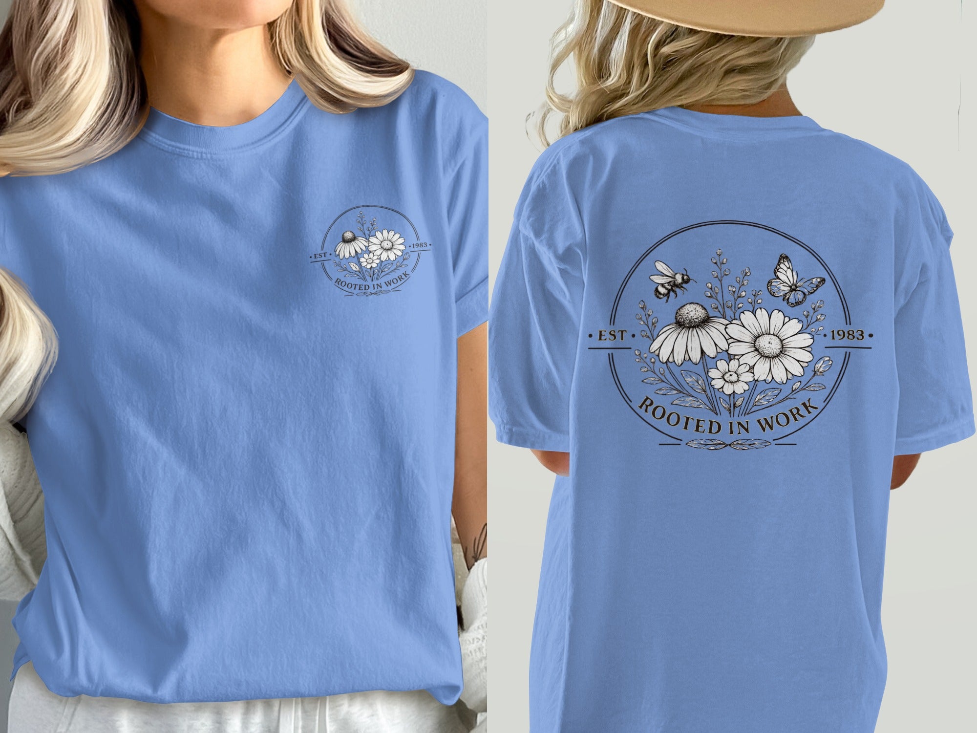 Blue t-shirt with a black and white floral circle logo featuring bees and the text "EST. 1983 ROOTED IN WORK".