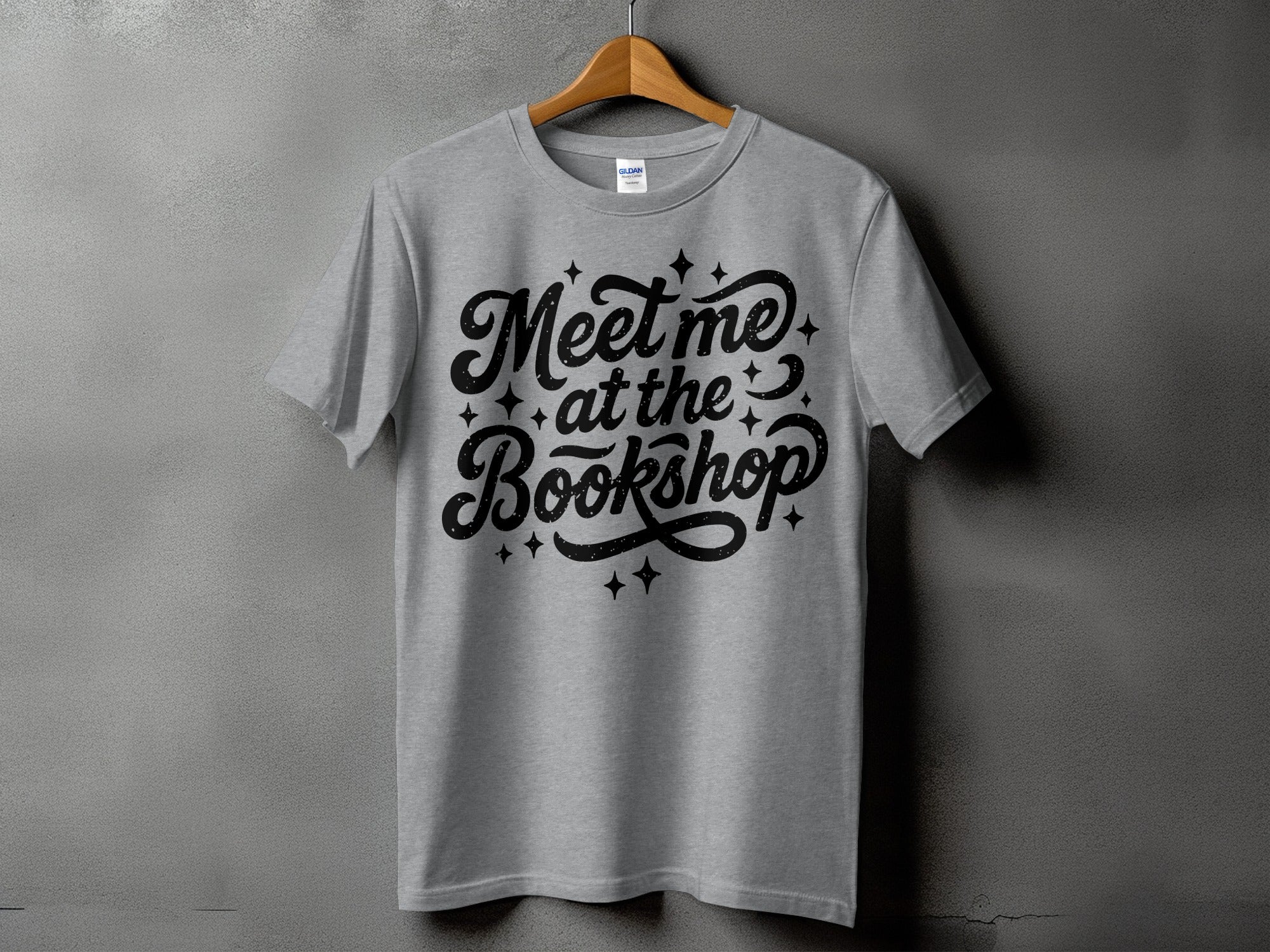 Grey t-shirt with black text reading "Meet me at the Bookshop".