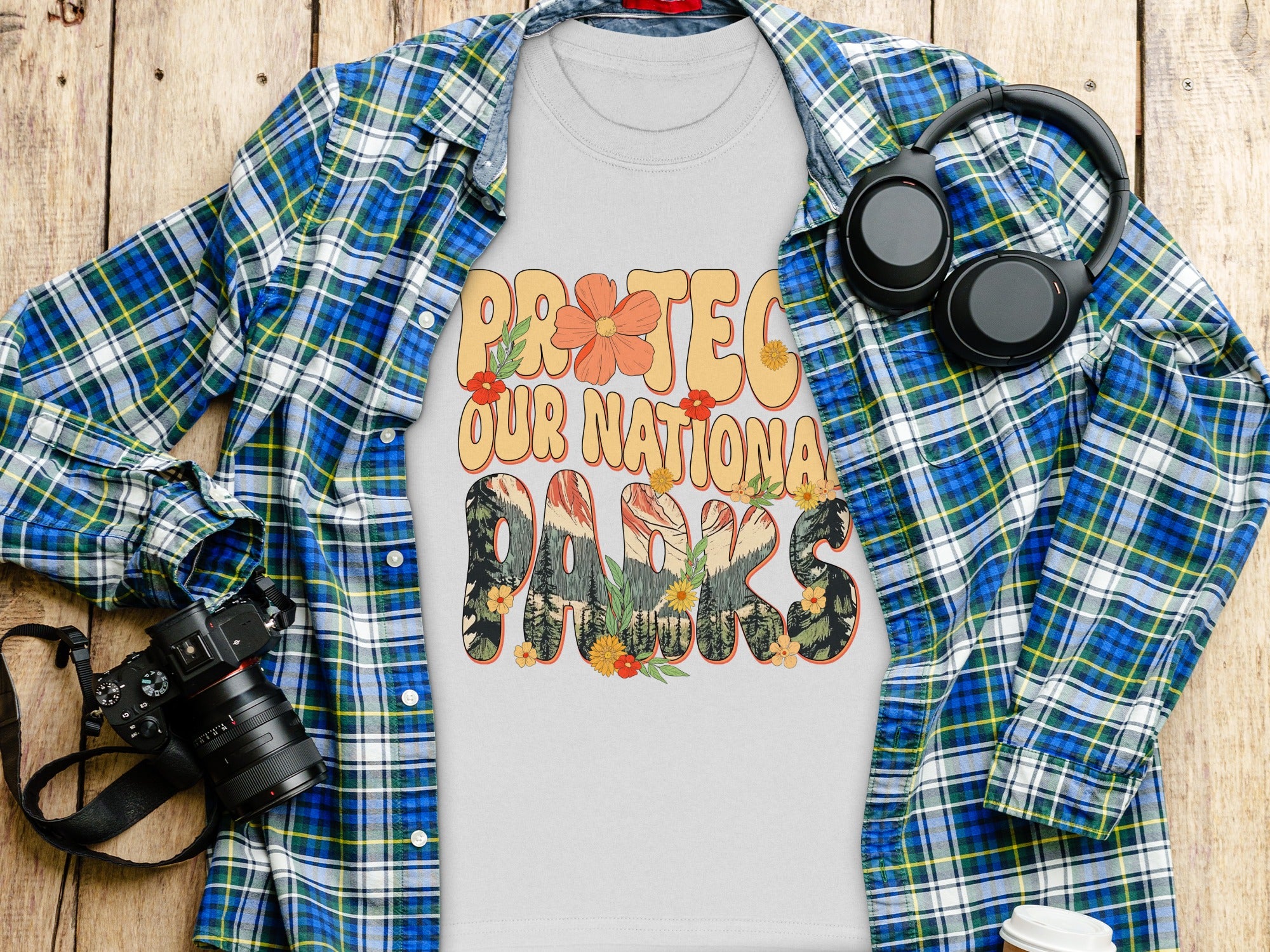 Grey t-shirt with "PROTEC OUR NATIONAL PARKS" graphic and floral details.