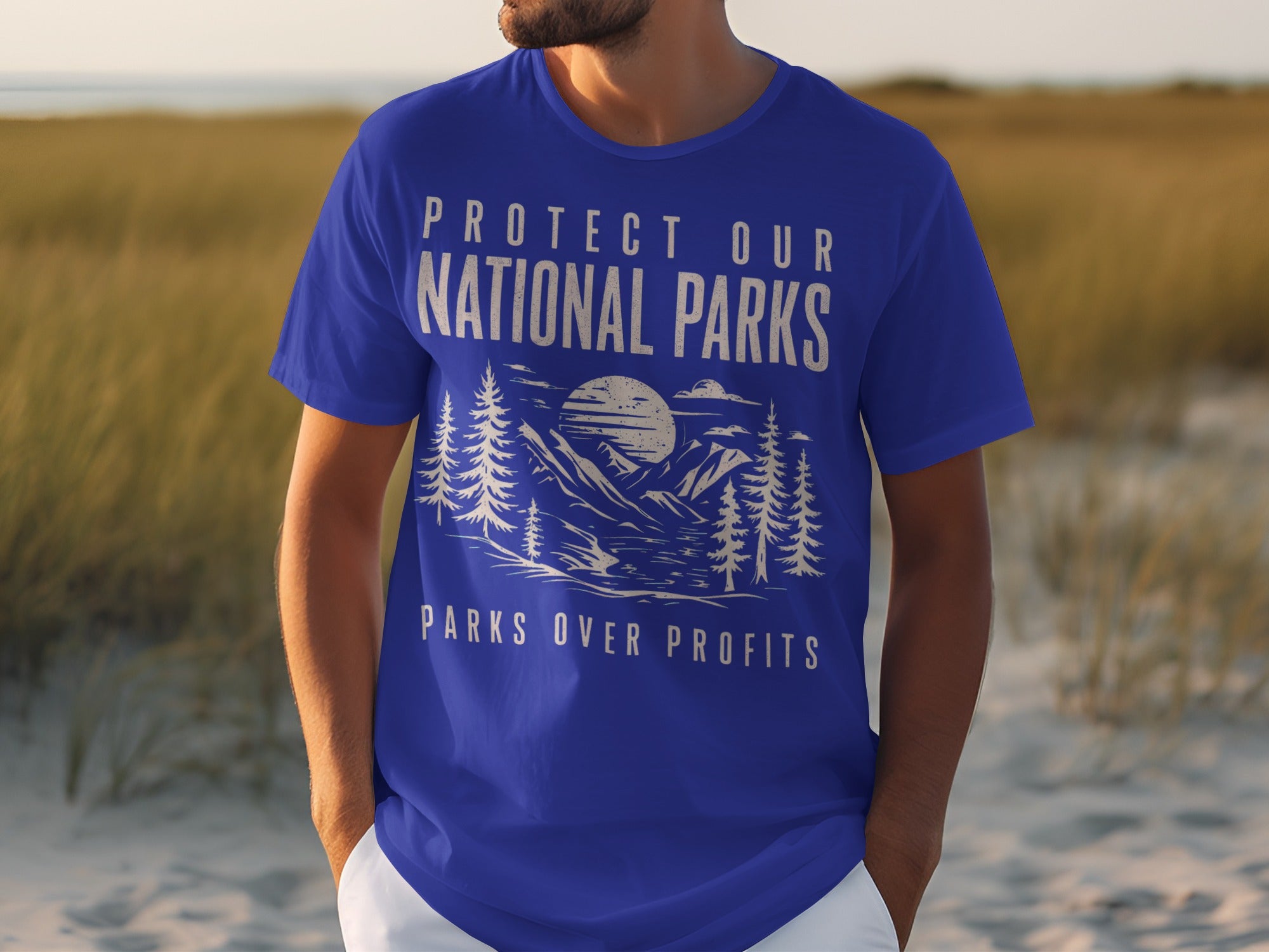 Blue t-shirt with white text "Protect Our National Parks" above a scenic mountain and tree graphic.