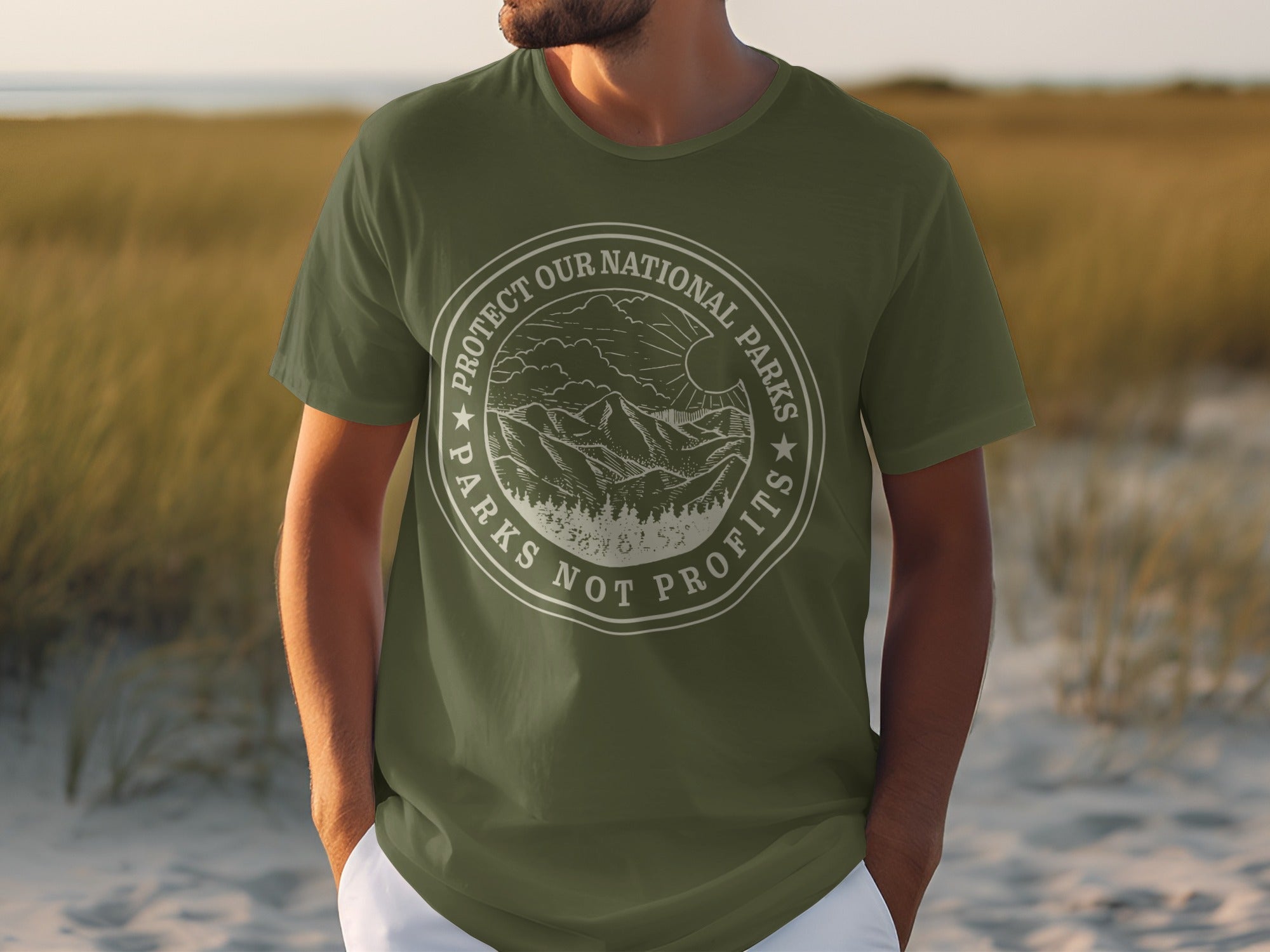 Olive green t-shirt with round graphic that reads "Protect Our National Parks Parks Not Profits".