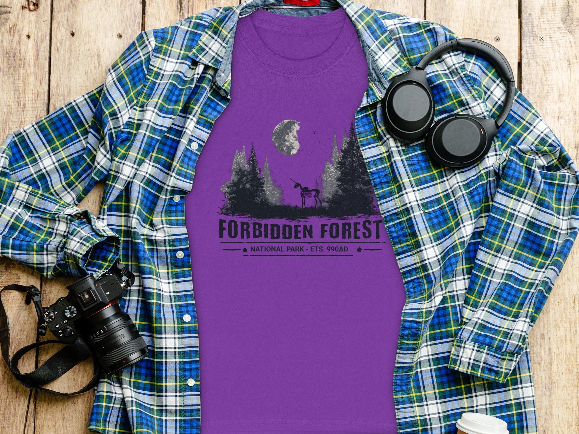 Purple t-shirt with "Forbidden Forest National Park" graphic and skeleton unicorn.