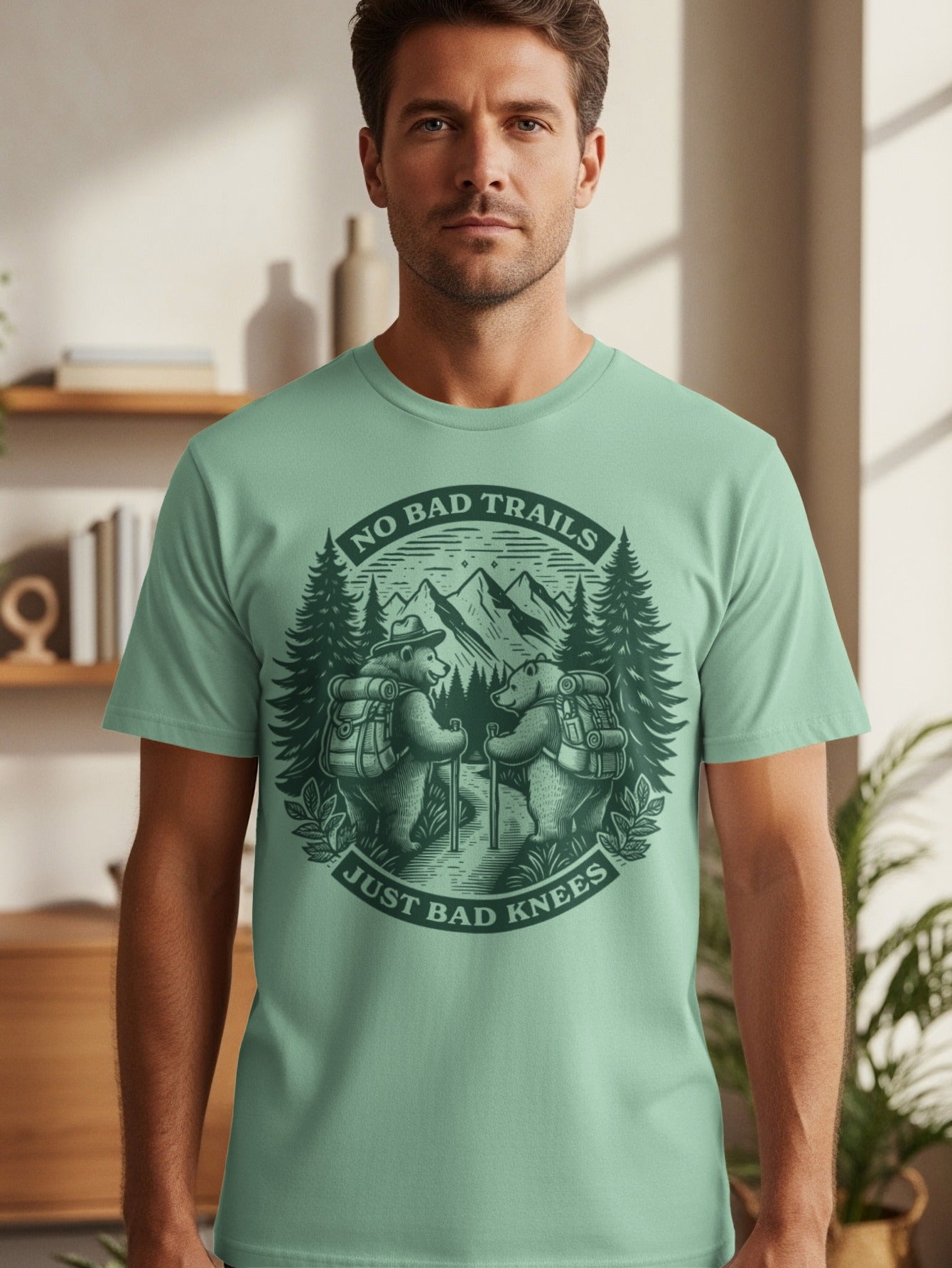 T-shirt with graphic of two bears hiking, mountains, trees, and text "No Bad Trails Just Bad Knees".