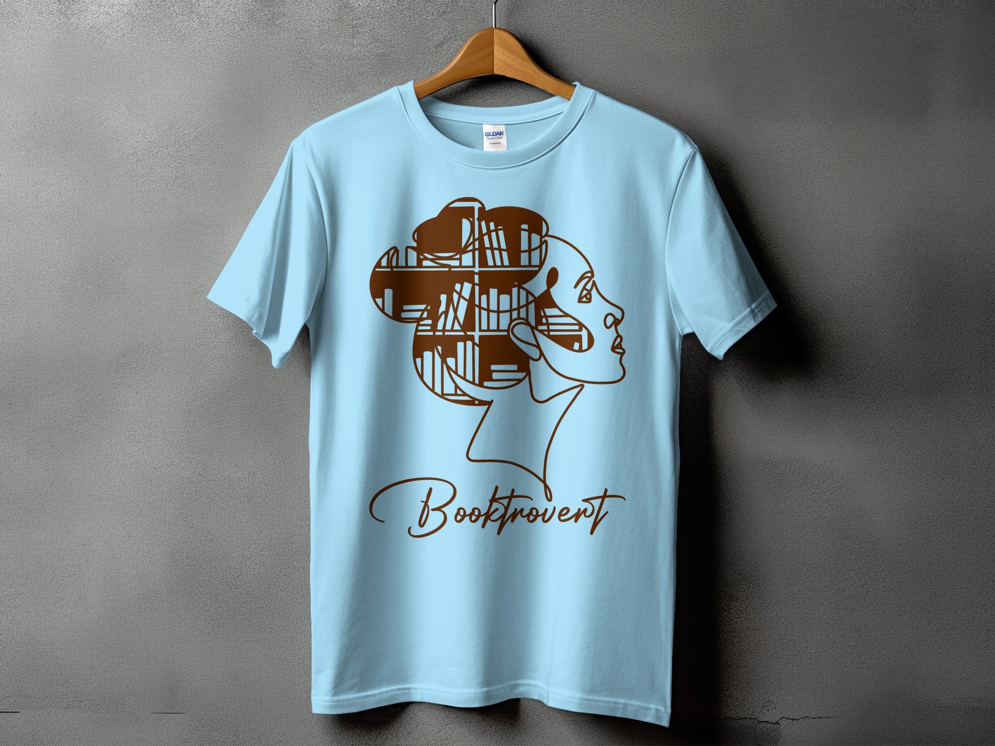 Light blue t-shirt with brown outline of a woman's profile and the word "Booktrovert".