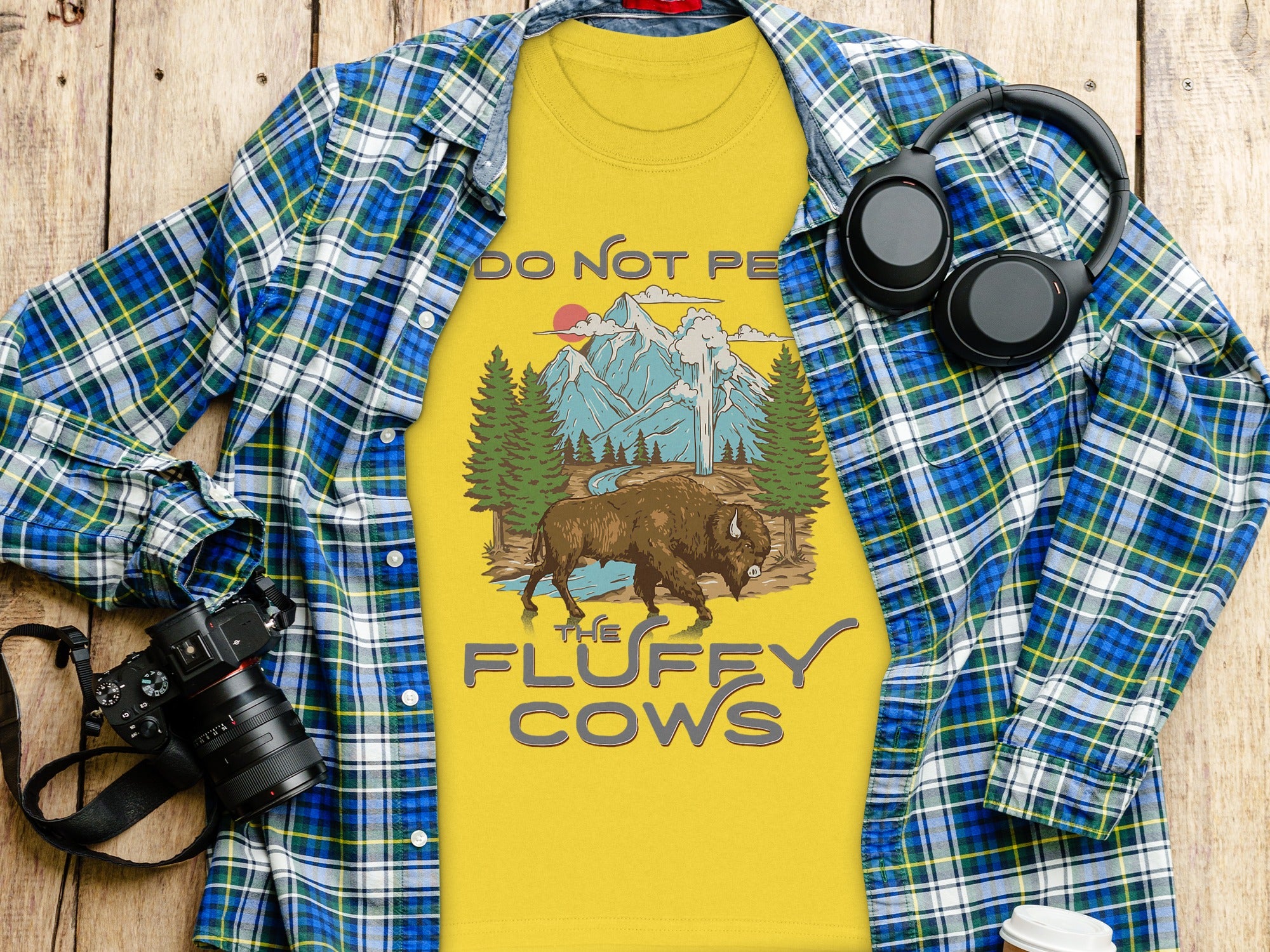 Yellow t-shirt with bison and mountains graphic, text "DO NOT PE THE FLUFFY COWS".