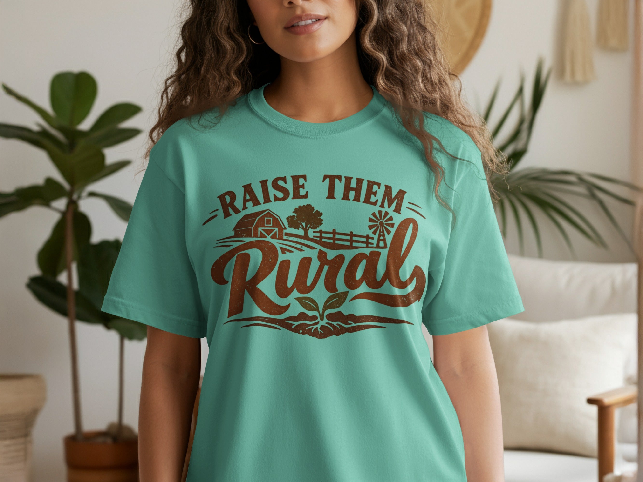 Teal t-shirt with "RAISE THEM Rural" text and farm graphic.