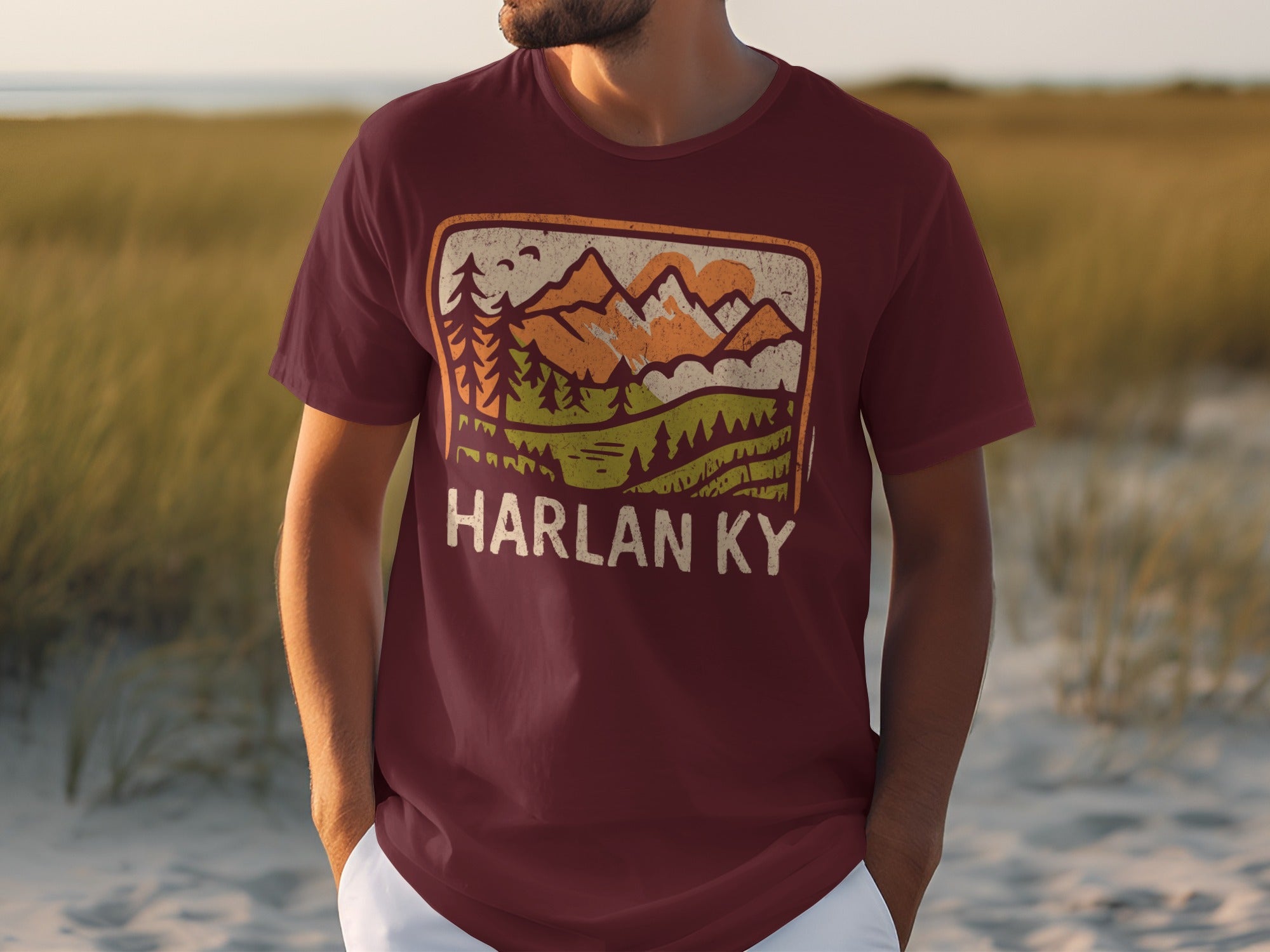 Maroon t-shirt with a vintage mountain landscape graphic and "HARLAN KY" text.