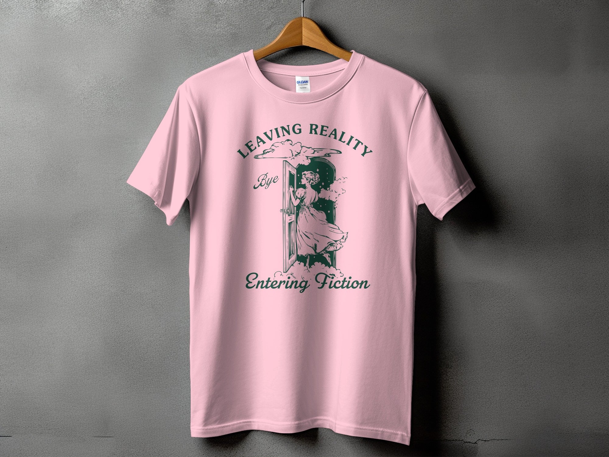 Pink t-shirt with "Leaving Reality" and "Entering Fiction" text and illustration.