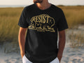 Black t-shirt with gold distressed buffalo and "RESIST US NATIONAL PARK" text.