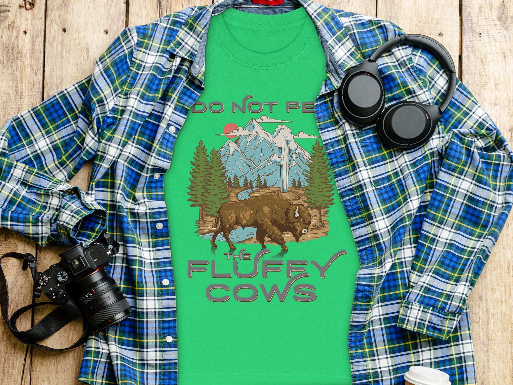 Green t-shirt with bison and mountains graphic, "Do Not Pet the Fluffy Cows" text.
