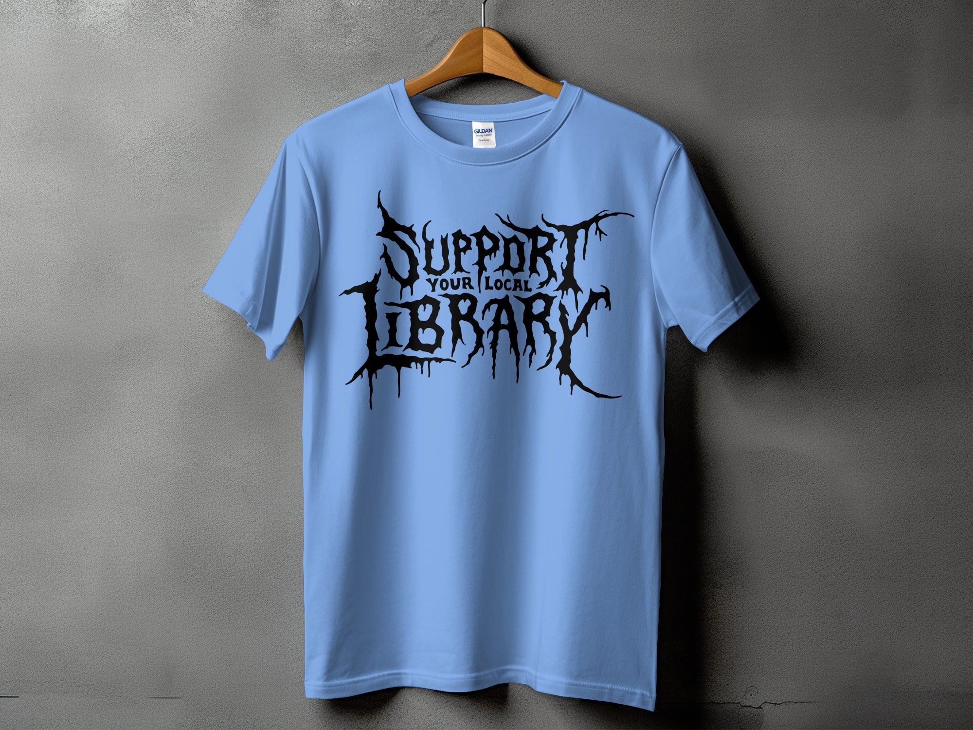 Light blue t-shirt with black "Support Your Local Library" text in gothic font.