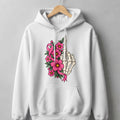 White hoodie with skeleton hand, pink flowers, and breast cancer ribbon graphic.