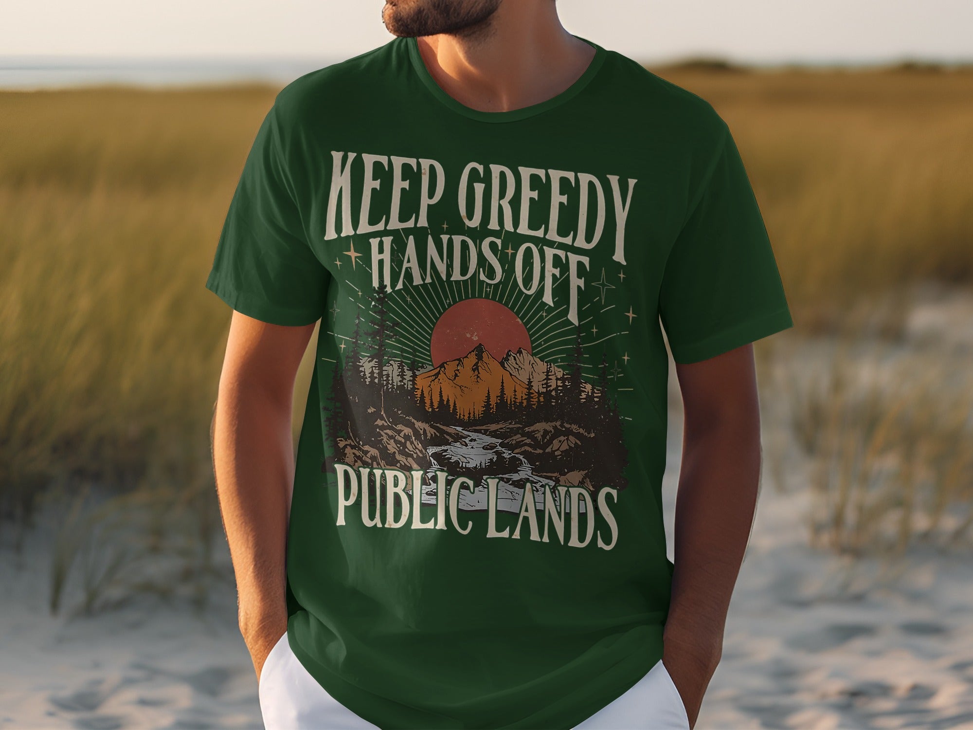 Green t-shirt with "Keep Greedy Hands Off Public Lands" text and mountain graphic.