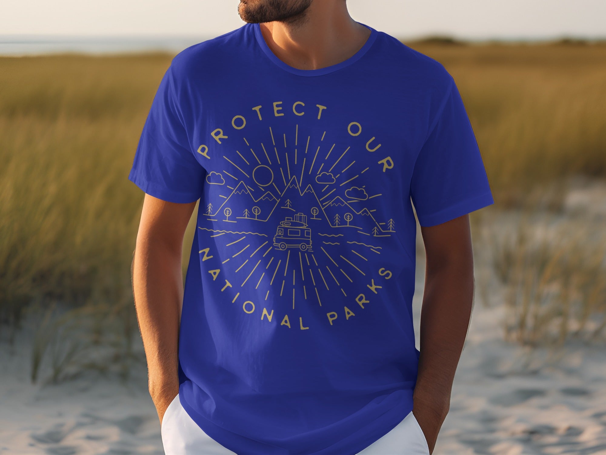 Blue t-shirt with a gold line art graphic of mountains, trees, a camper van, and the words "Protect Our National Parks."