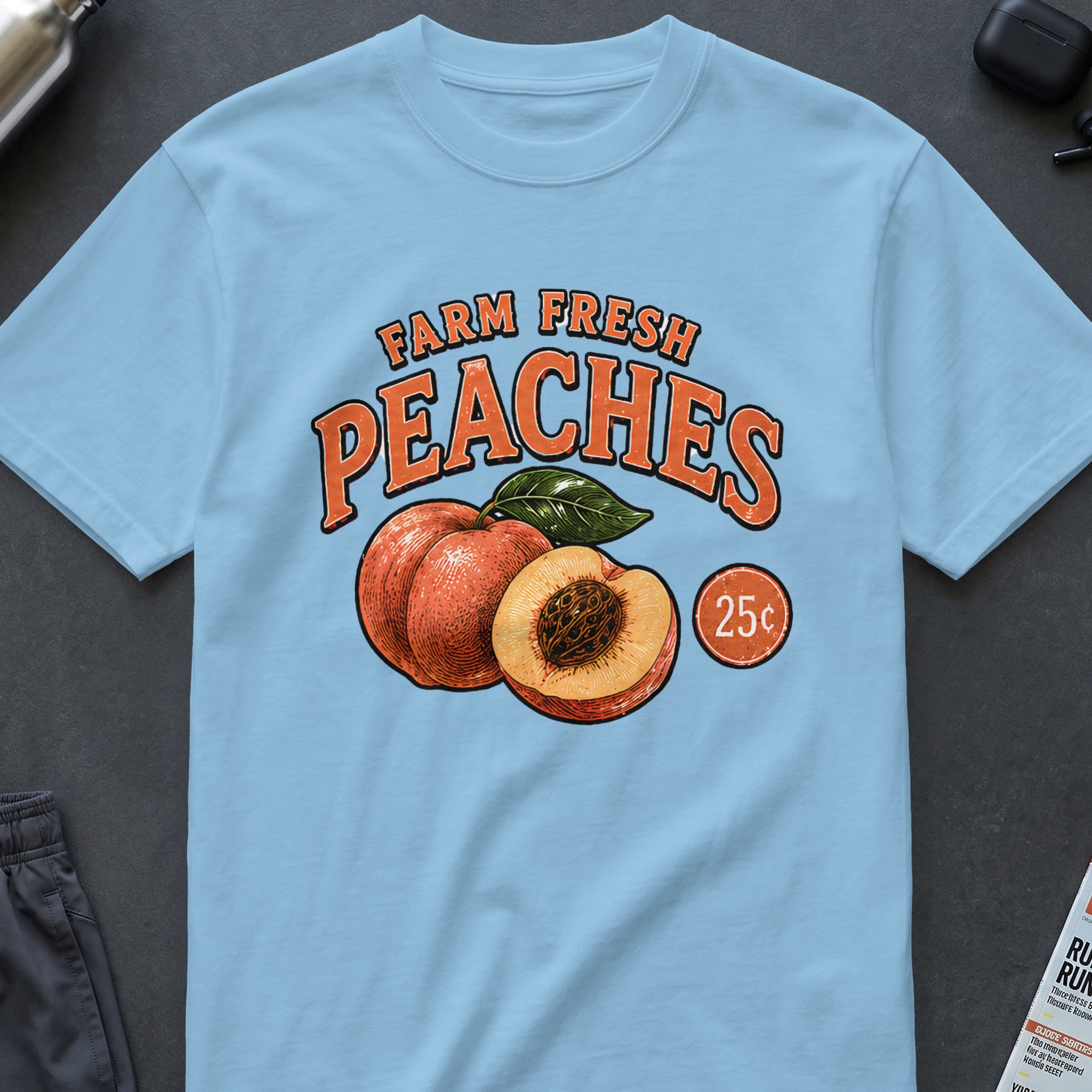 Light blue t-shirt with "Farm Fresh Peaches 25¢" graphic.