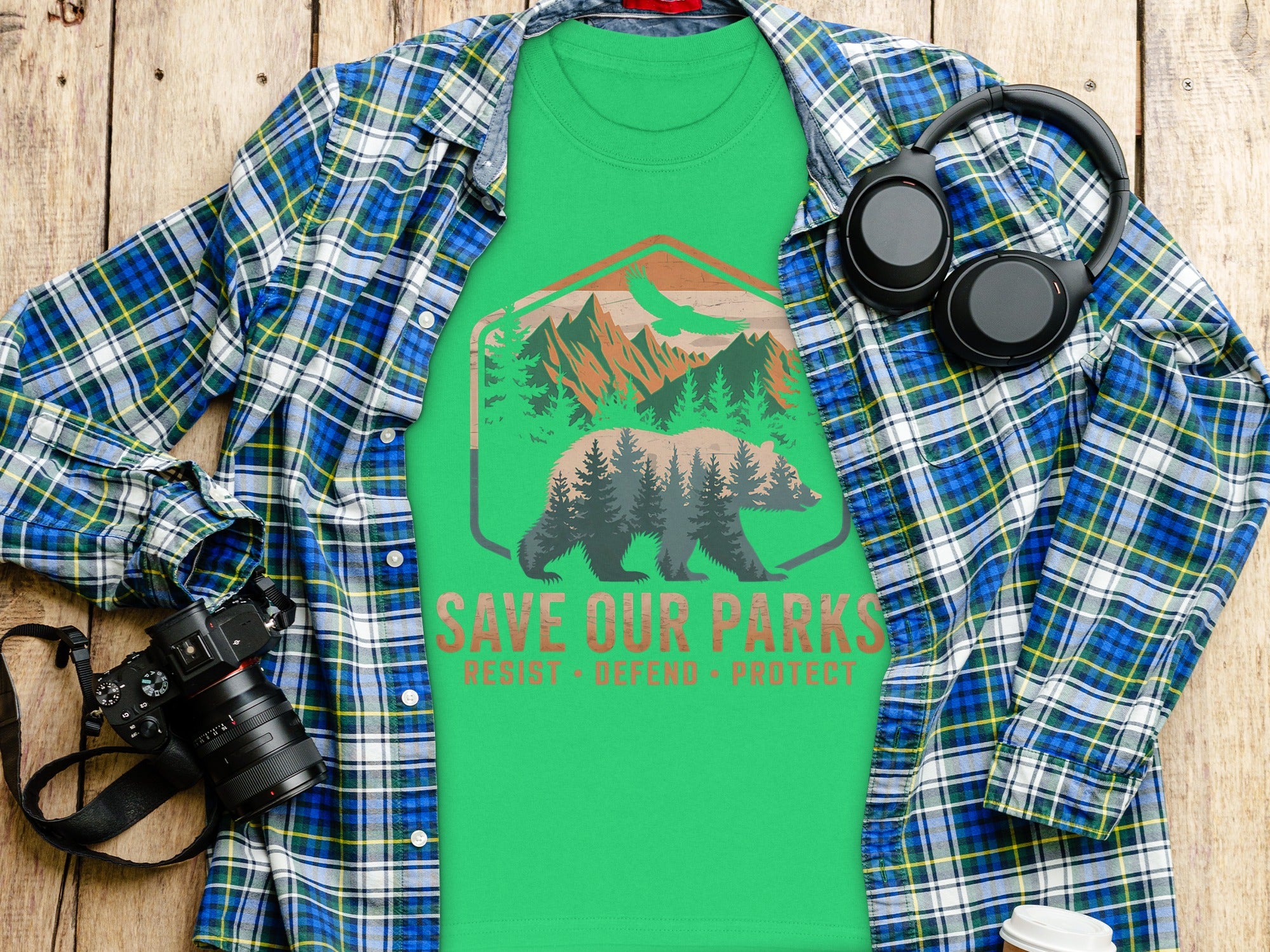 Green t-shirt with bear, mountains, and text "SAVE OUR PARKS RESIST. DEFEND. PROTECT."