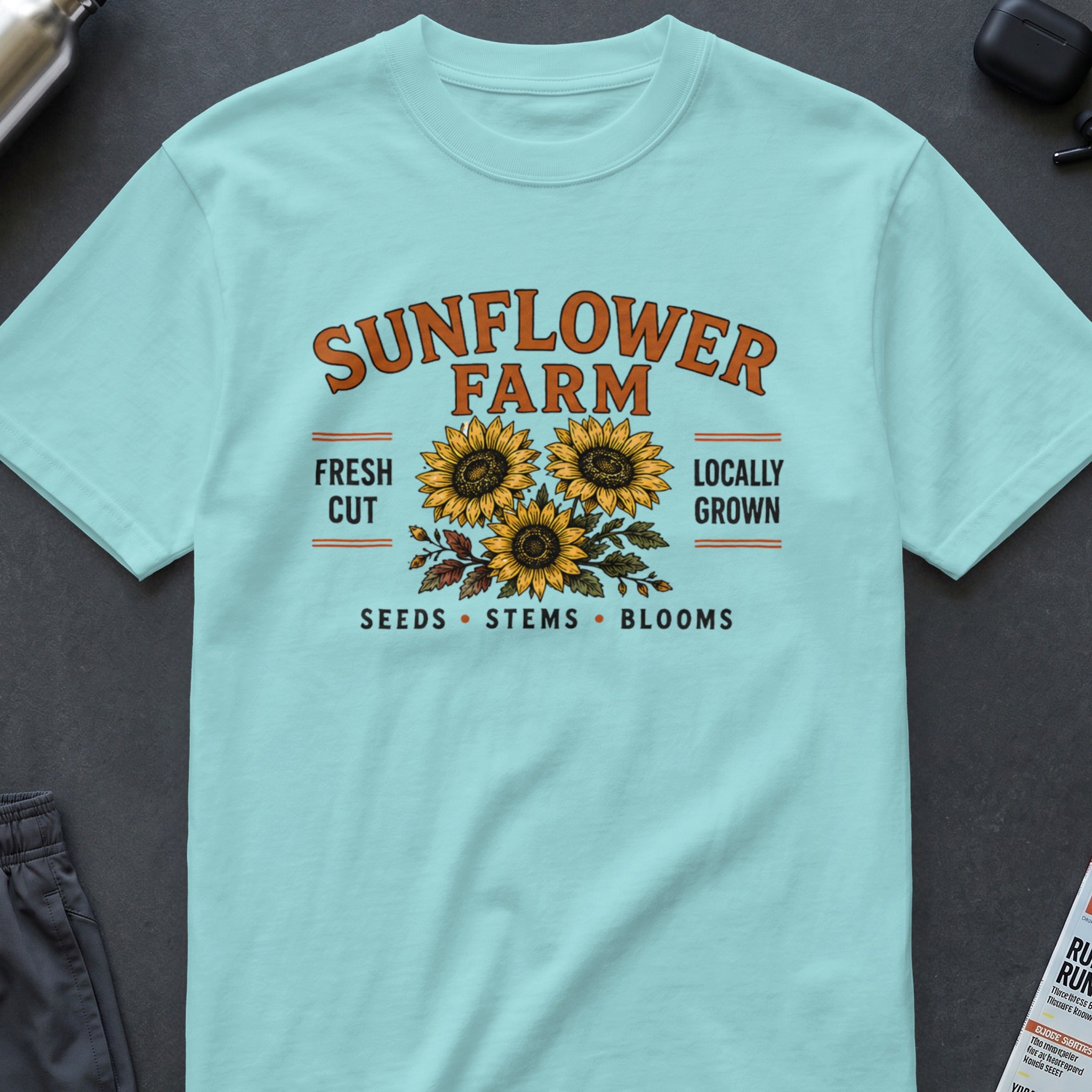 Turquoise t-shirt with "SUNFLOWER FARM" text and three sunflowers.