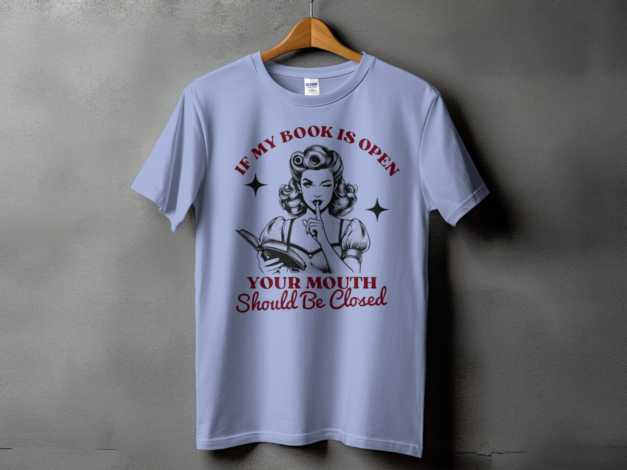 Light blue t-shirt with "If My Book is Open Your Mouth Should Be Closed" text and vintage illustration.
