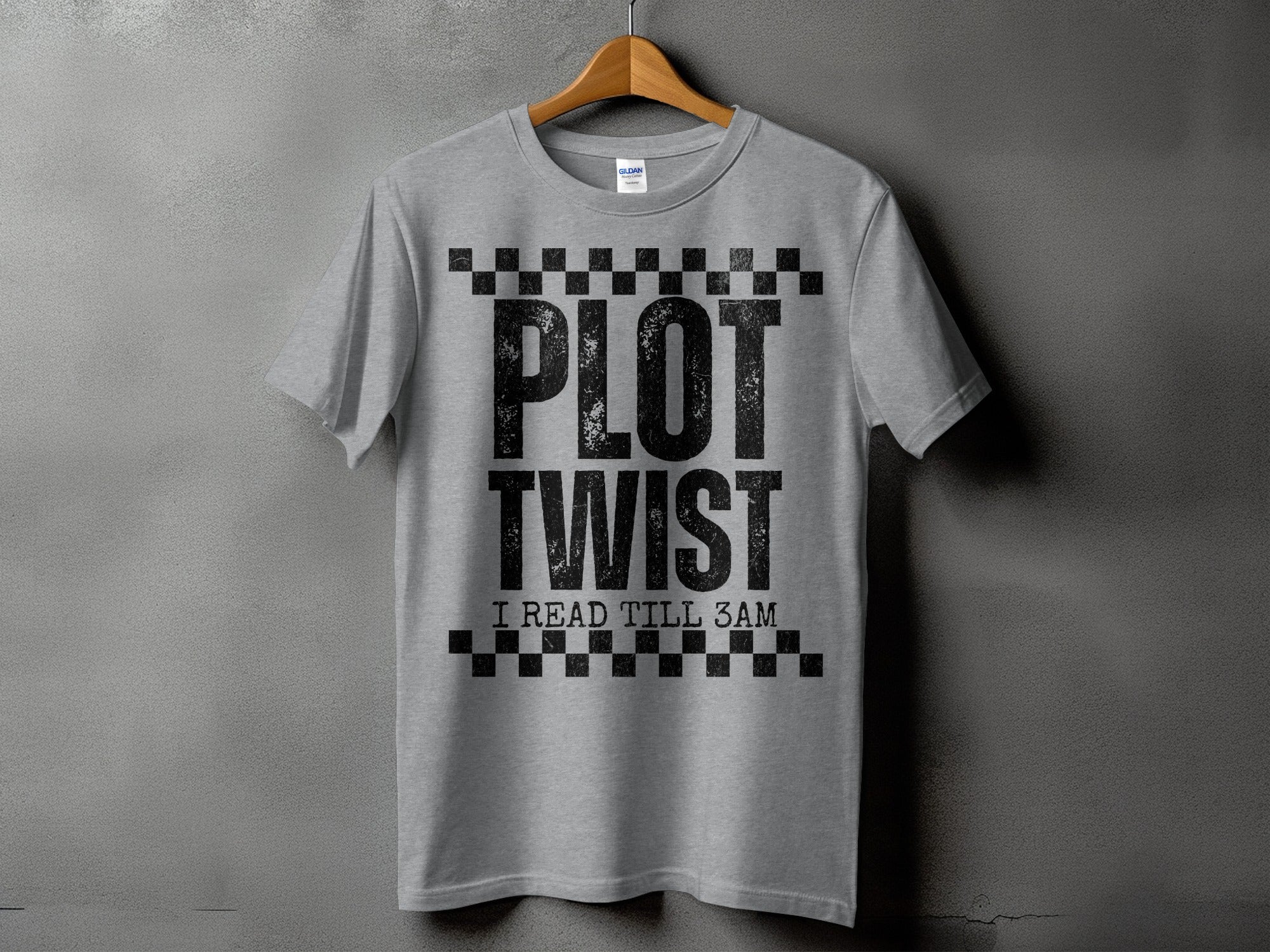 Gray t-shirt with "PLOT TWIST I READ TILL 3AM" text and checkerboard design.