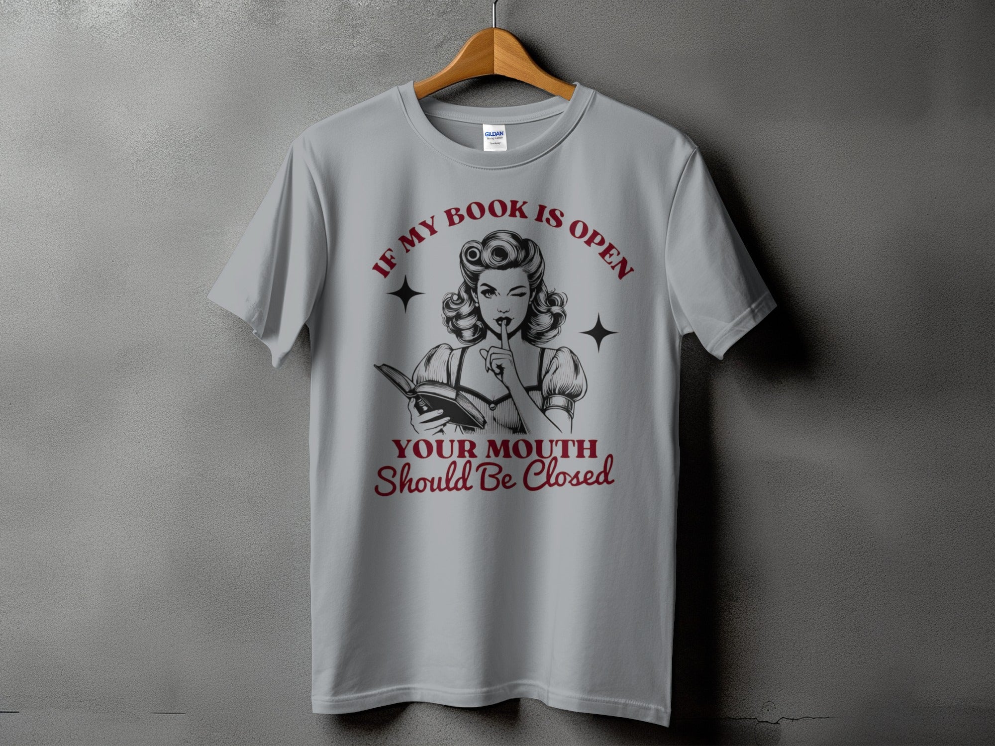 Grey t-shirt with "If My Book Is Open, Your Mouth Should Be Closed" graphic.
