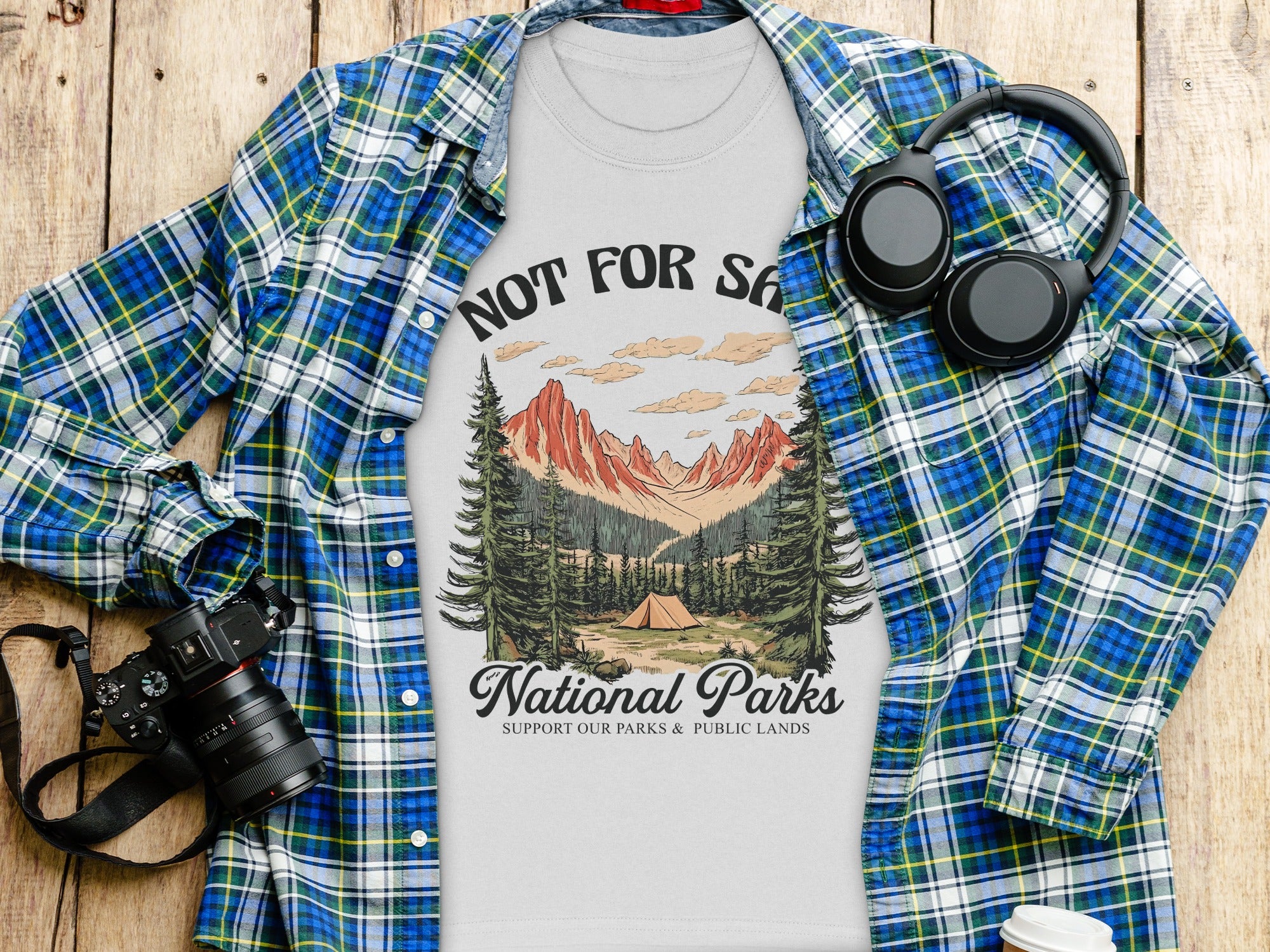 T-shirt with "Not For S*" text and national park graphic, featuring headphones and camera.