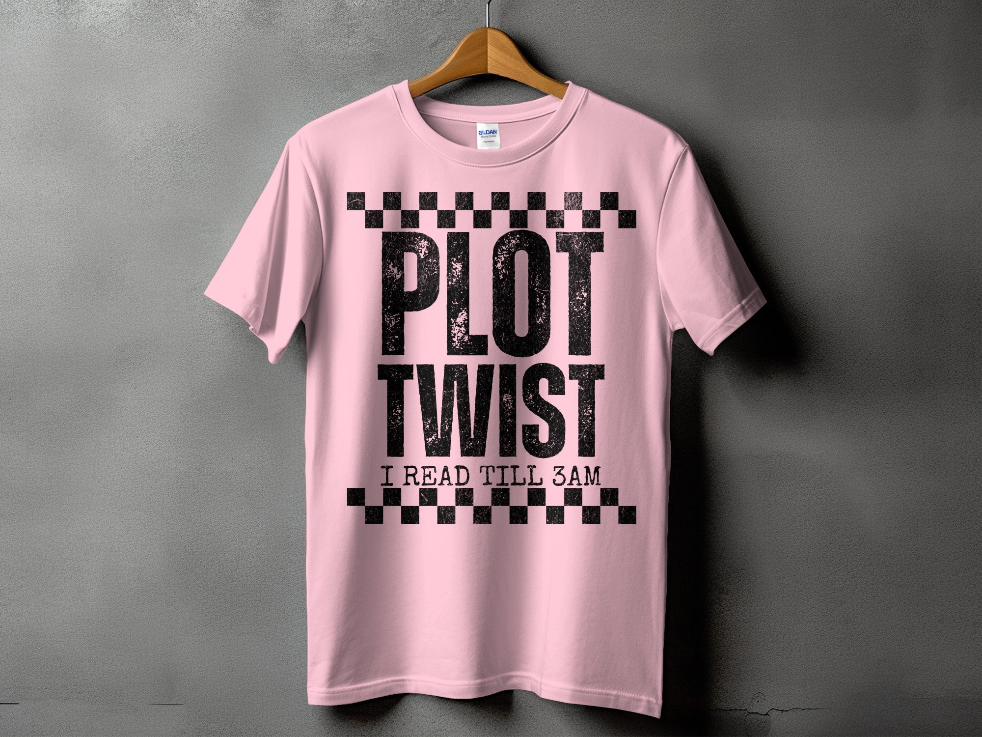 Pink t-shirt with black text reading "PLOT TWIST I READ TILL 3AM".