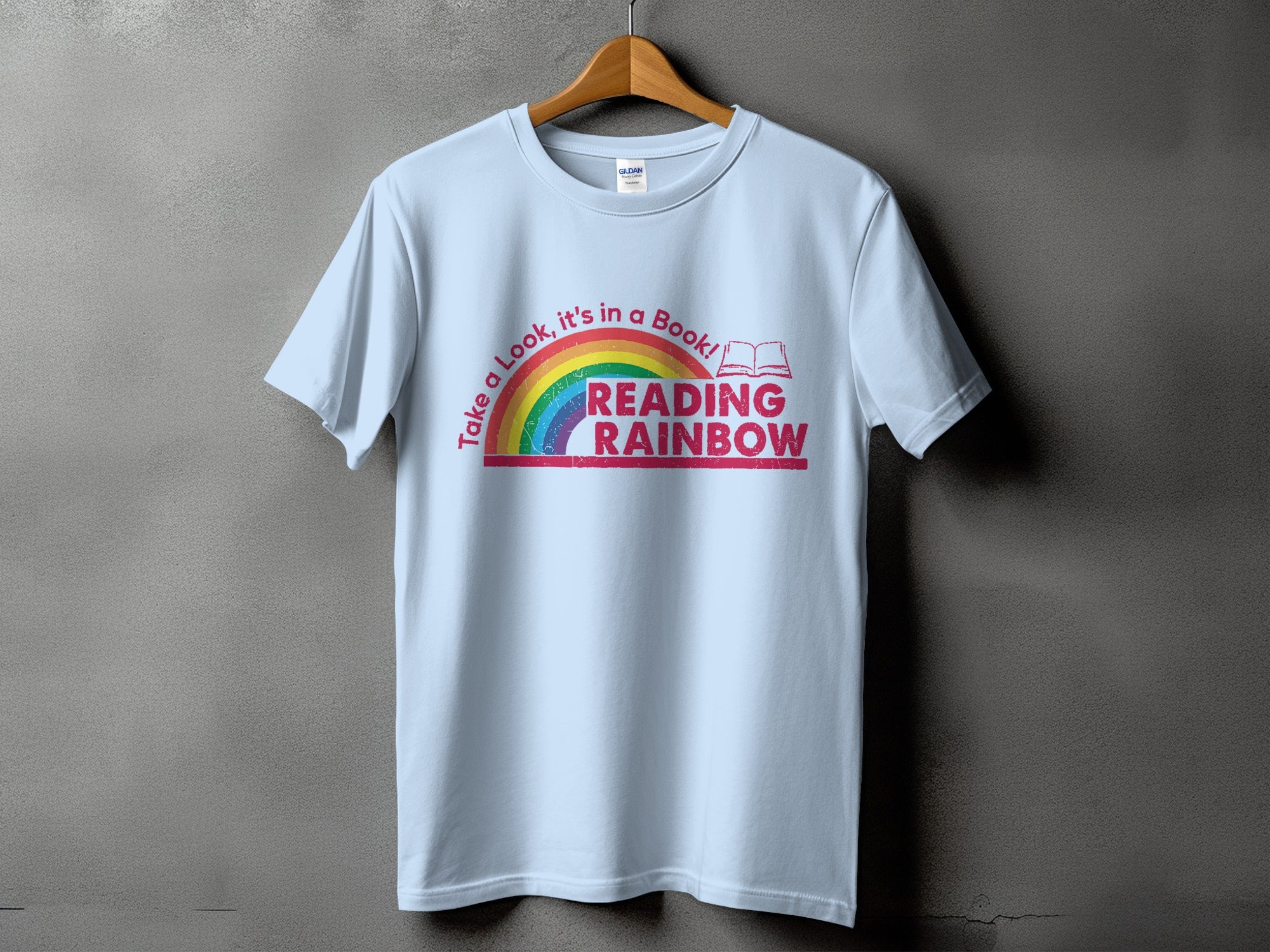 Light blue t-shirt with "Reading Rainbow" text and rainbow graphic.