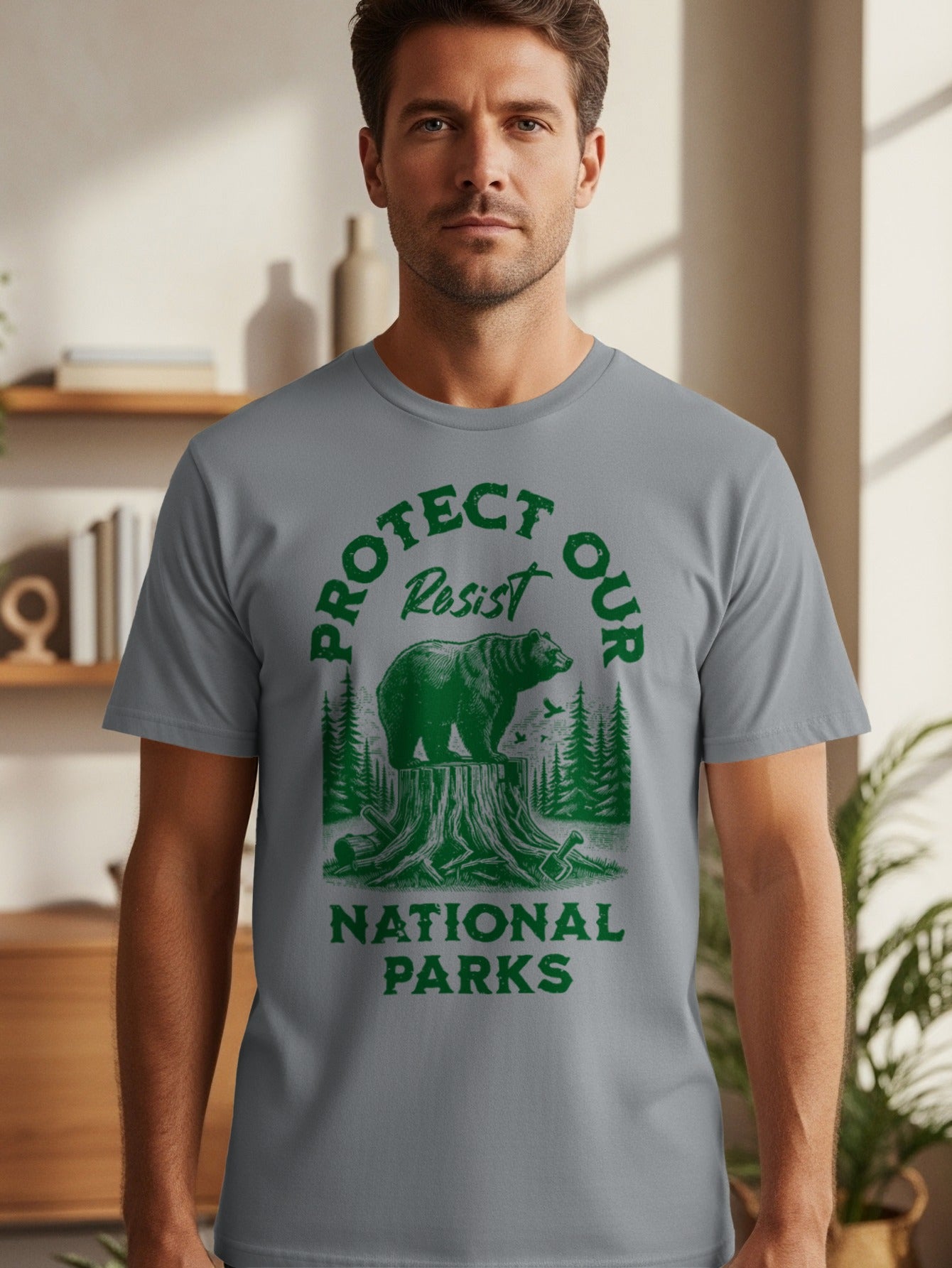 Grey t-shirt with green graphic reading "Protect Our Resist" and a bear on a stump.