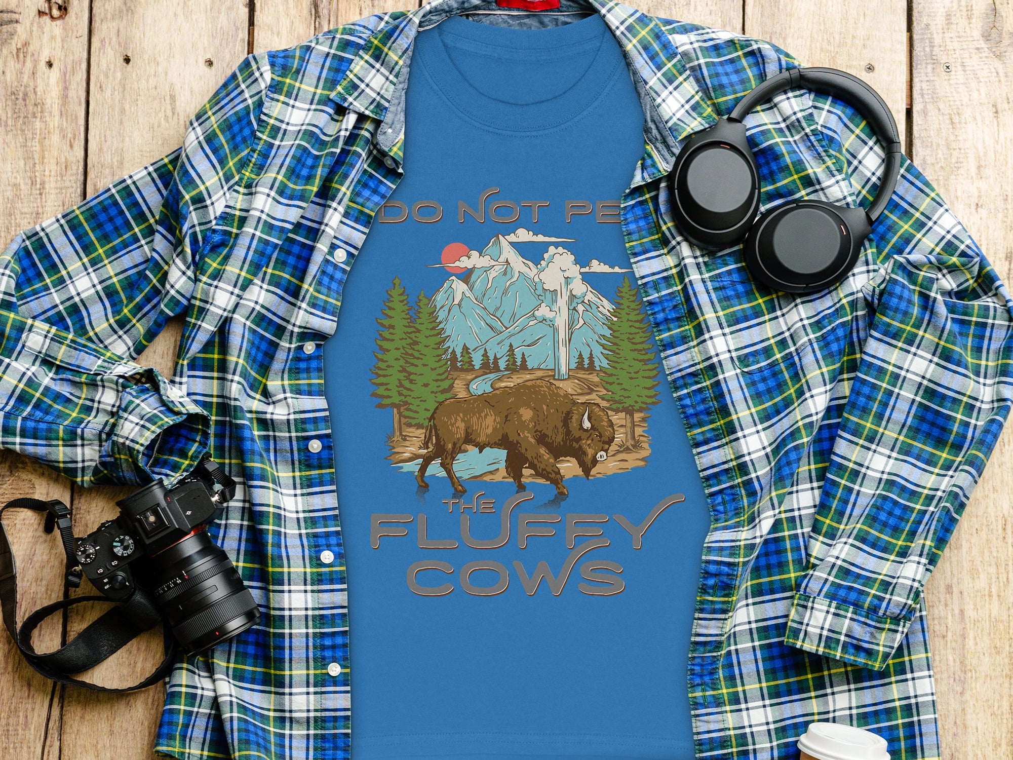 Blue t-shirt with buffalo, mountains, and text "Do Not Pet The Fluffy Cows."