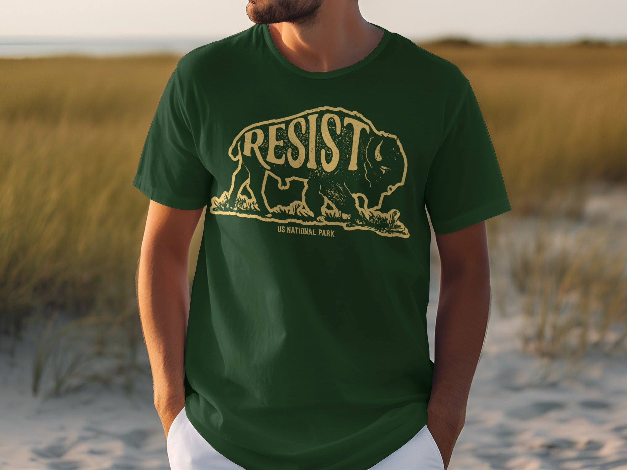 Green t-shirt with a distressed yellow bison graphic and "RESIST" text, below it "US National Park".