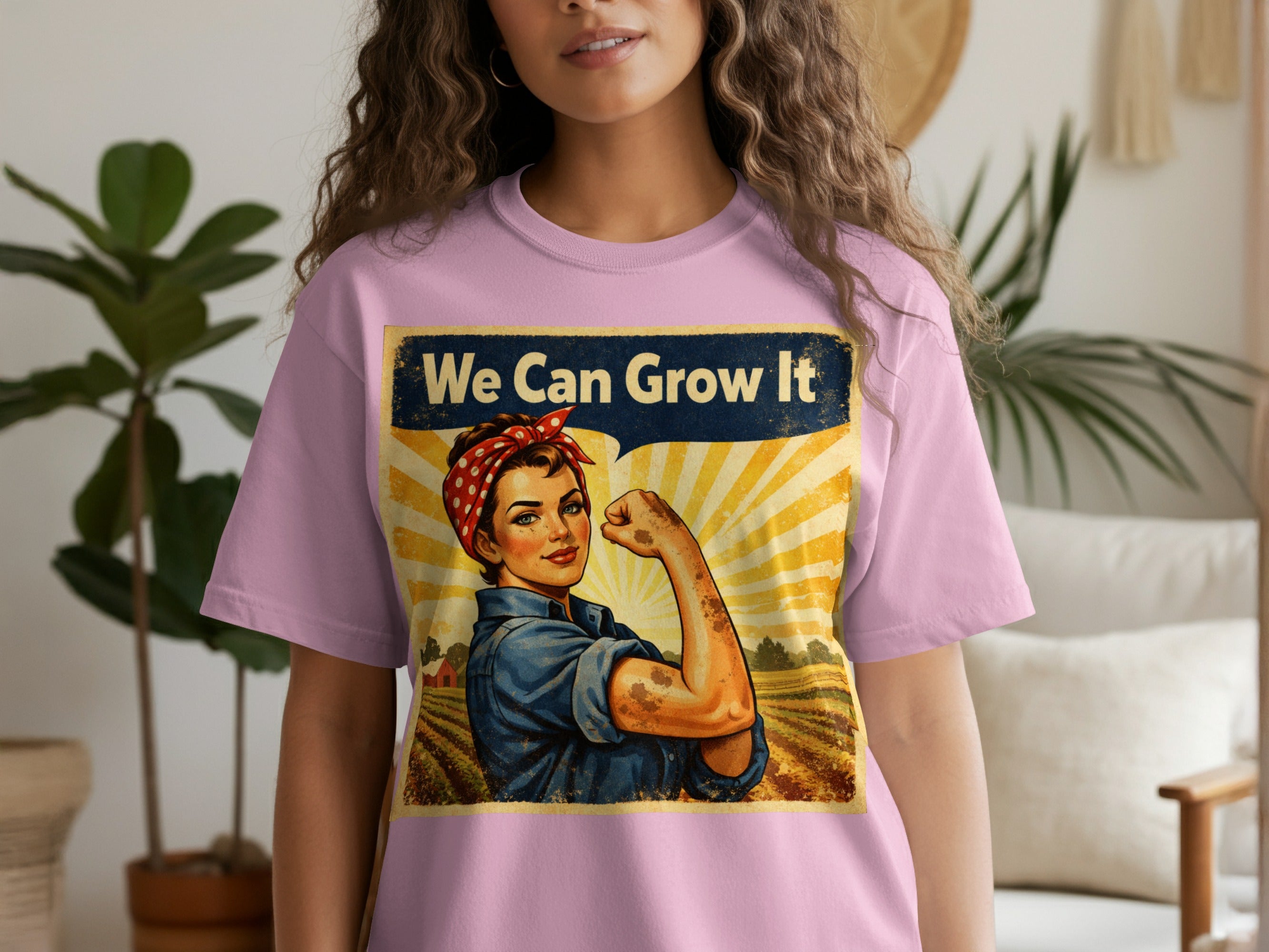 Rosie the Riveter themed graphic with text "We Can Grow It" on a pink t-shirt.