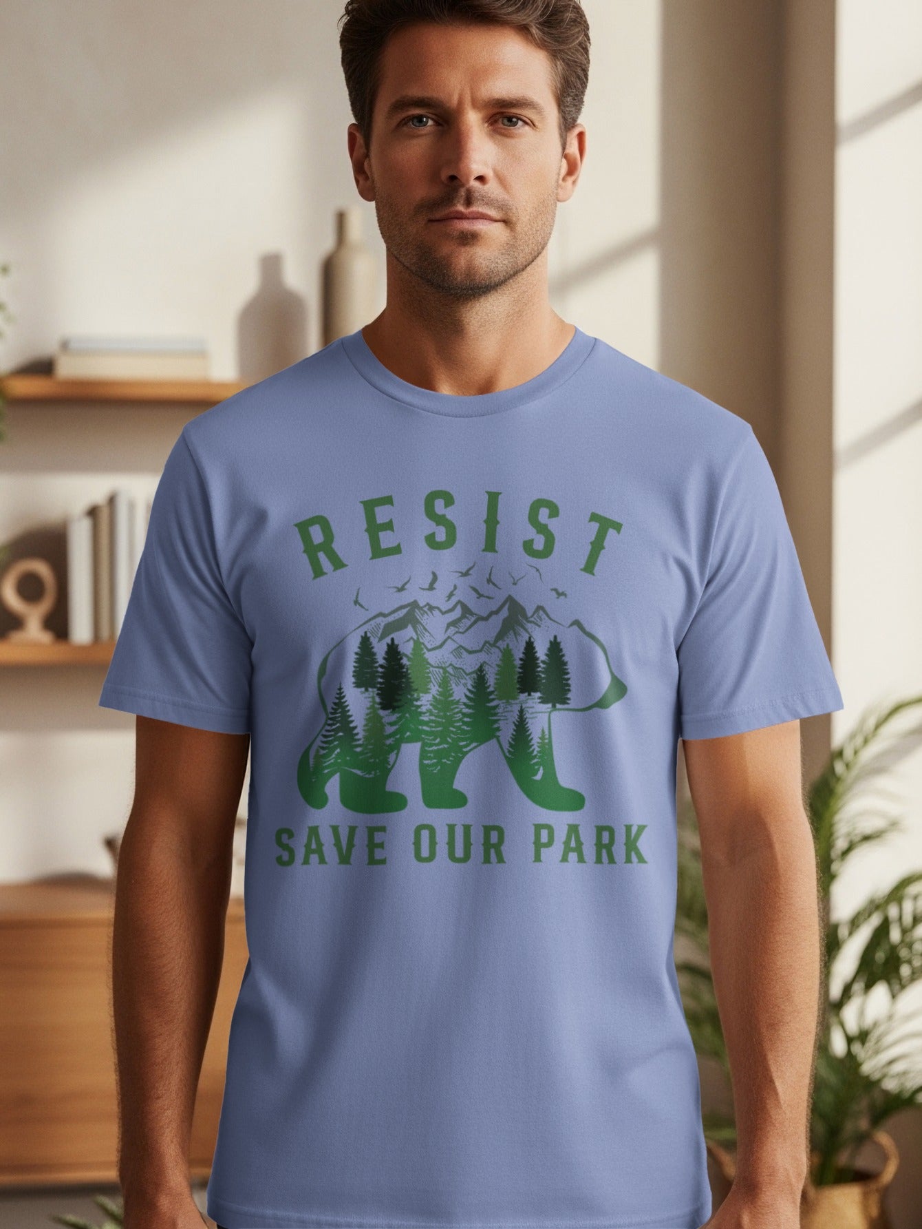 Blue t-shirt with 'RESIST SAVE OUR PARK' text and a bear filled with trees and mountains.