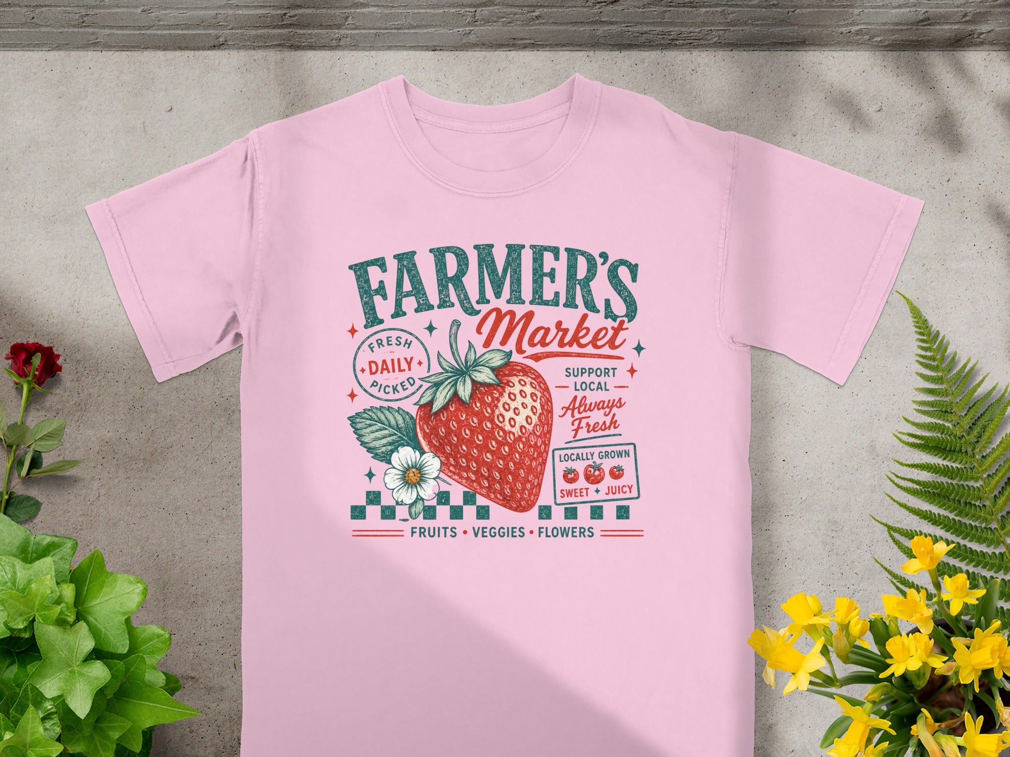 Pink t-shirt with "Farmer's Market" text and strawberry graphic.