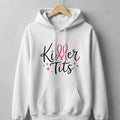 White hoodie with "Killer Tits" text and pink ribbons.
