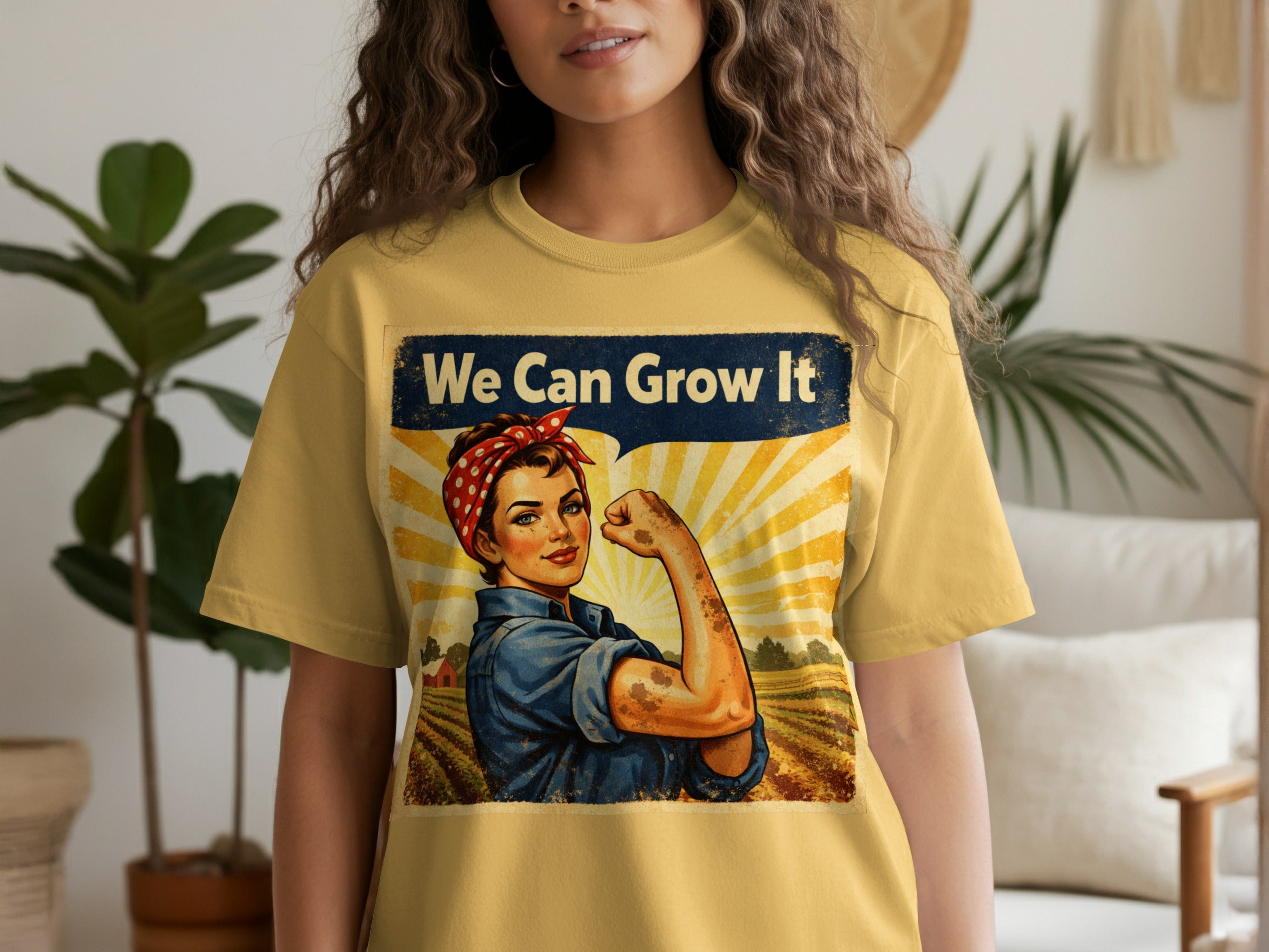 Yellow t-shirt featuring cartoon Rosie the Riveter and text "We Can Grow It".
