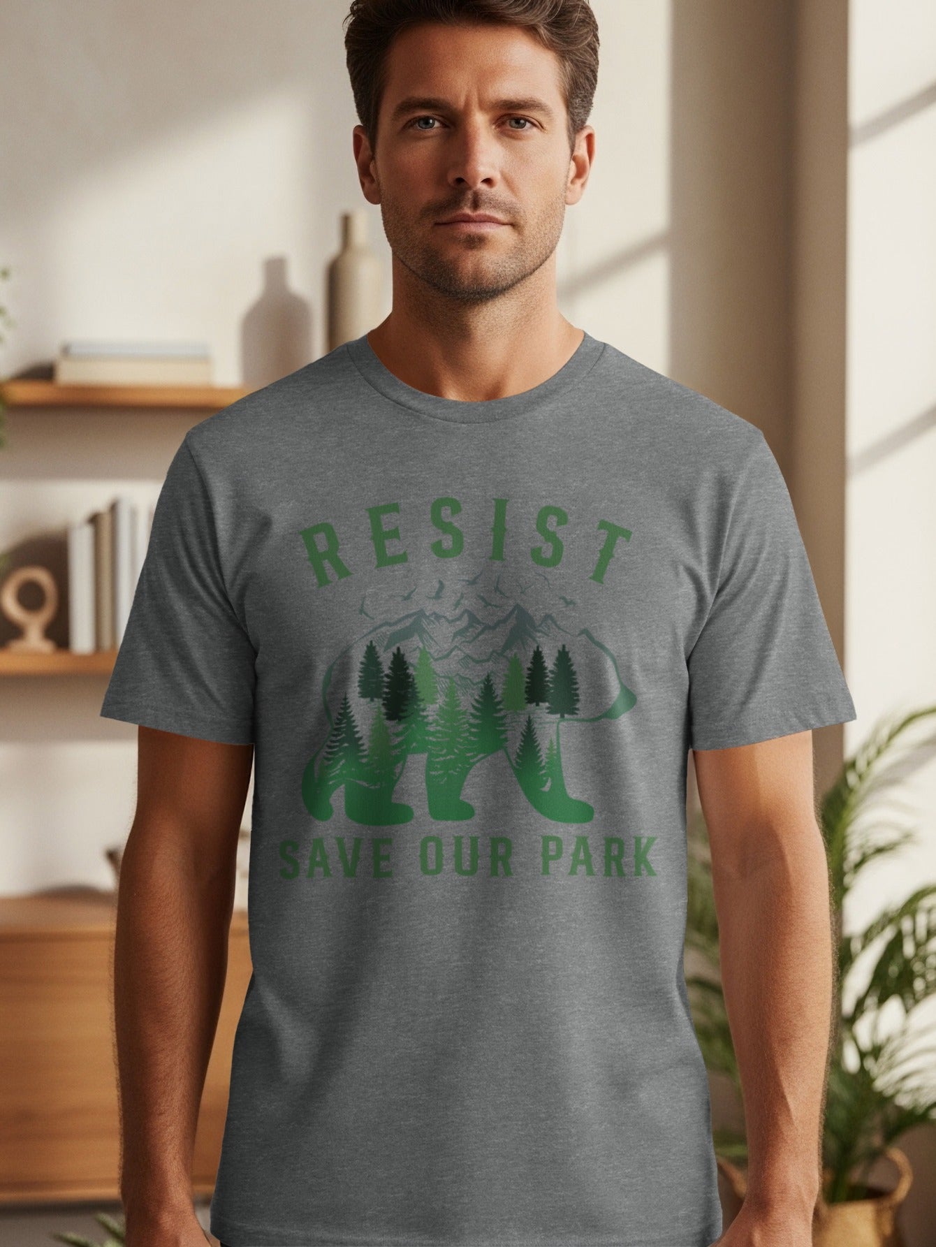Men's grey t-shirt with "RESIST SAVE OUR PARK" text and bear silhouette with trees.