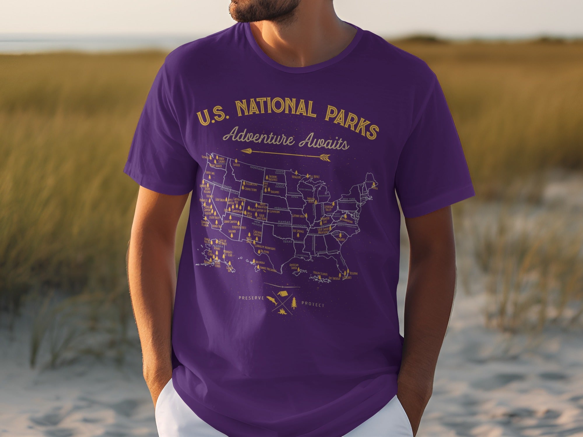 Purple t-shirt with yellow U.S. National Parks map and "Adventure Awaits" text.