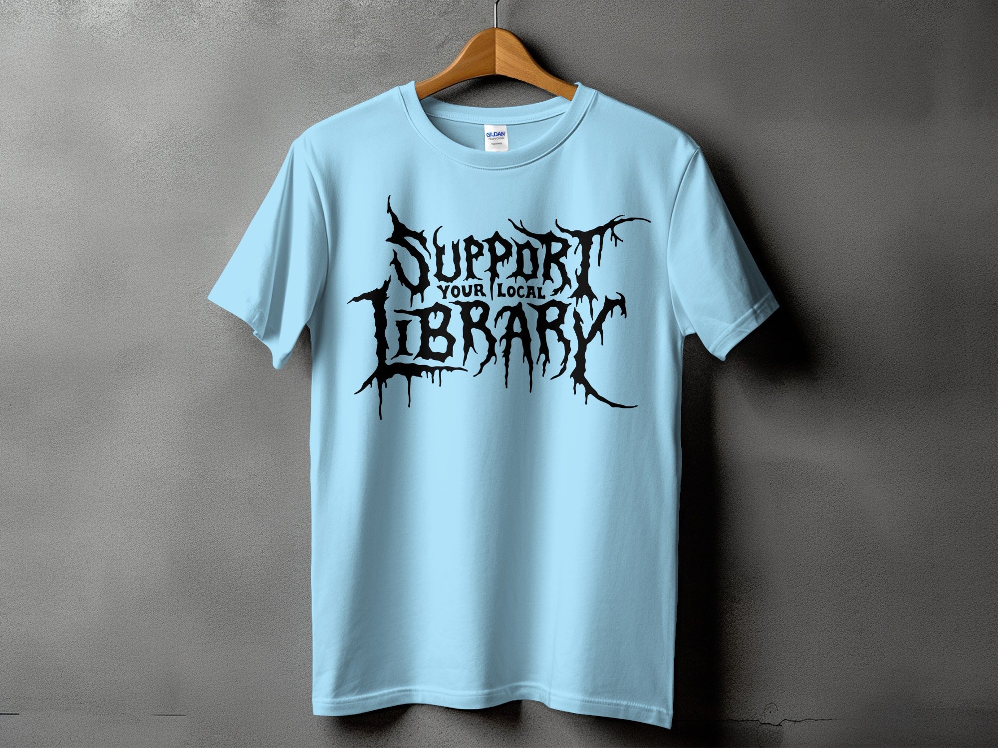 Light blue t-shirt with black graphic text "SUPPORT YOUR LOCAL LIBRARY".