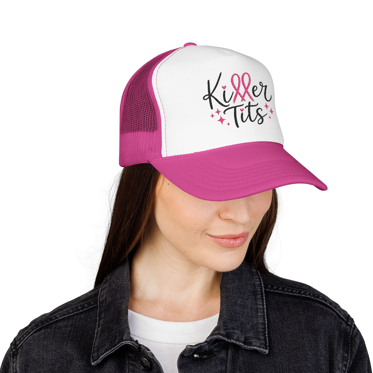 Pink and white trucker hat with "Killer Tits" text and pink ribbon graphic.