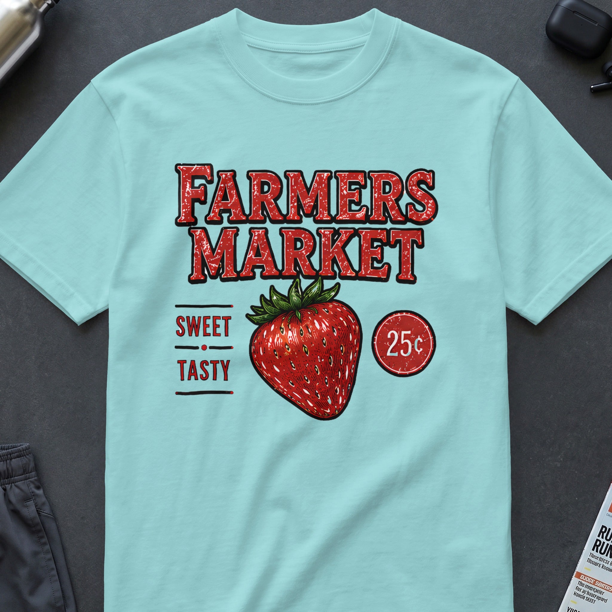 Light blue t-shirt with "FARMERS MARKET" text, strawberry, and "25¢" graphic.