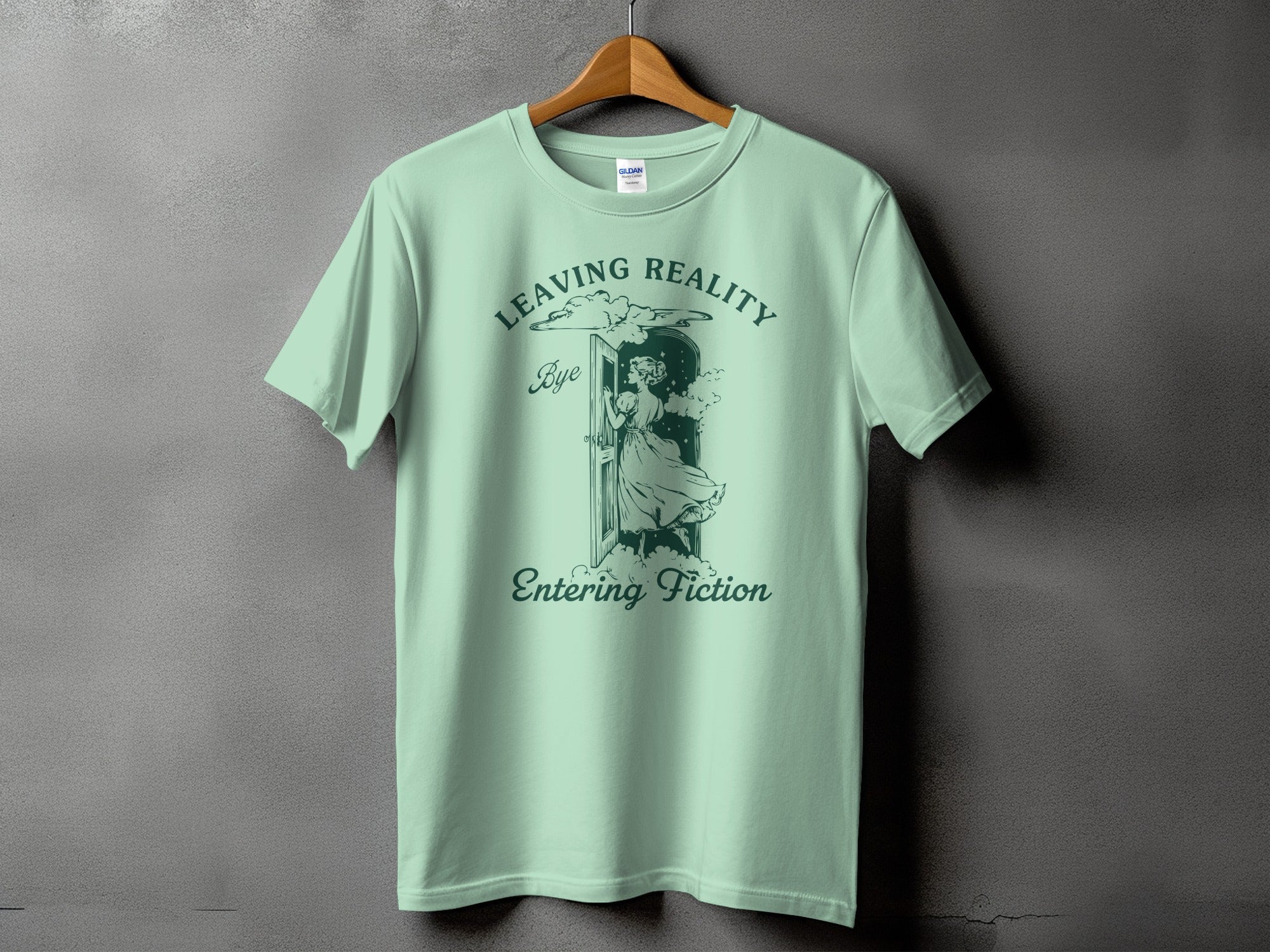 Light green t-shirt with "Leaving Reality" and "Entering Fiction" text and illustration.