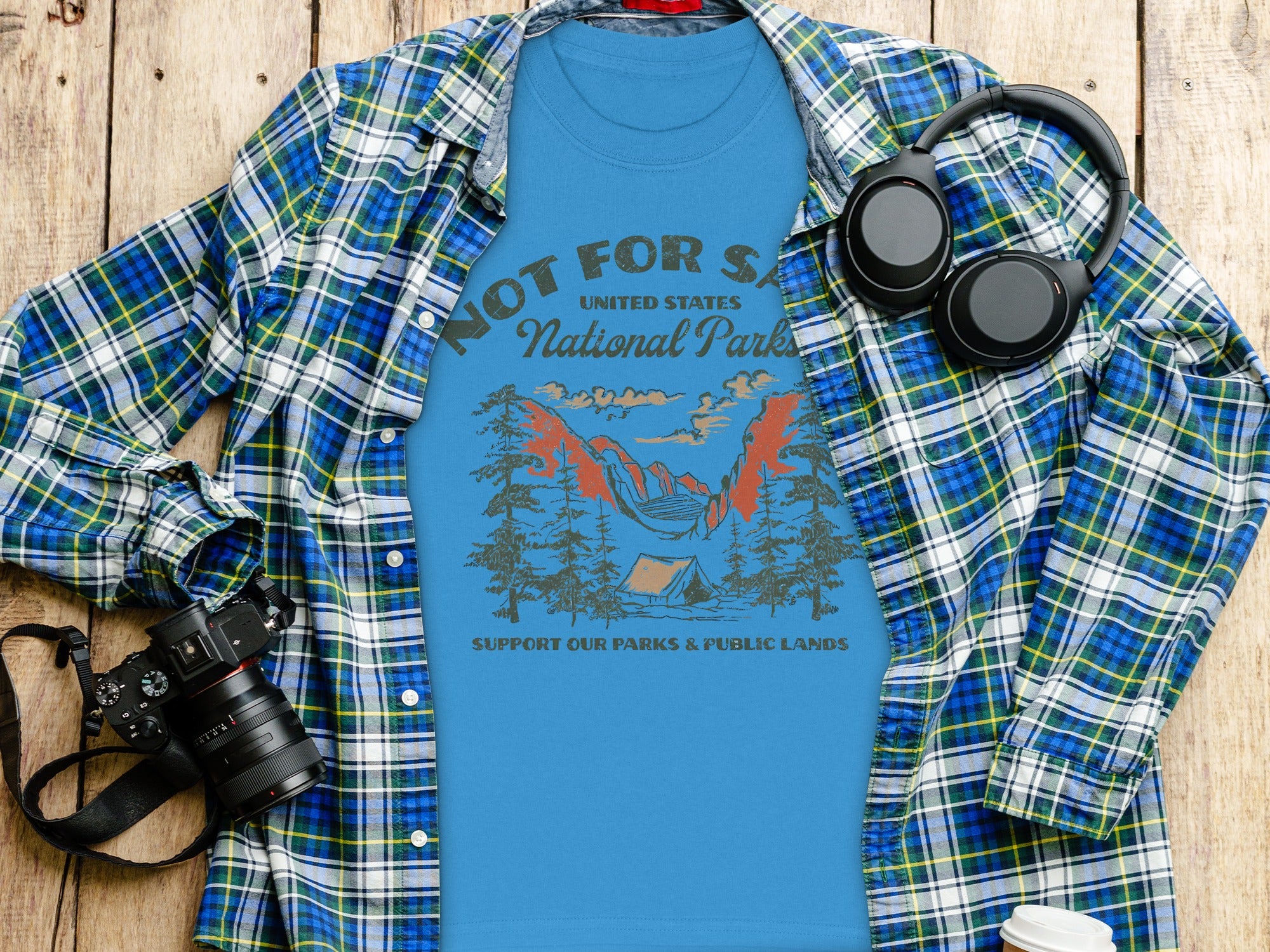 Blue t-shirt with mountains, tent, and text "National Parks".