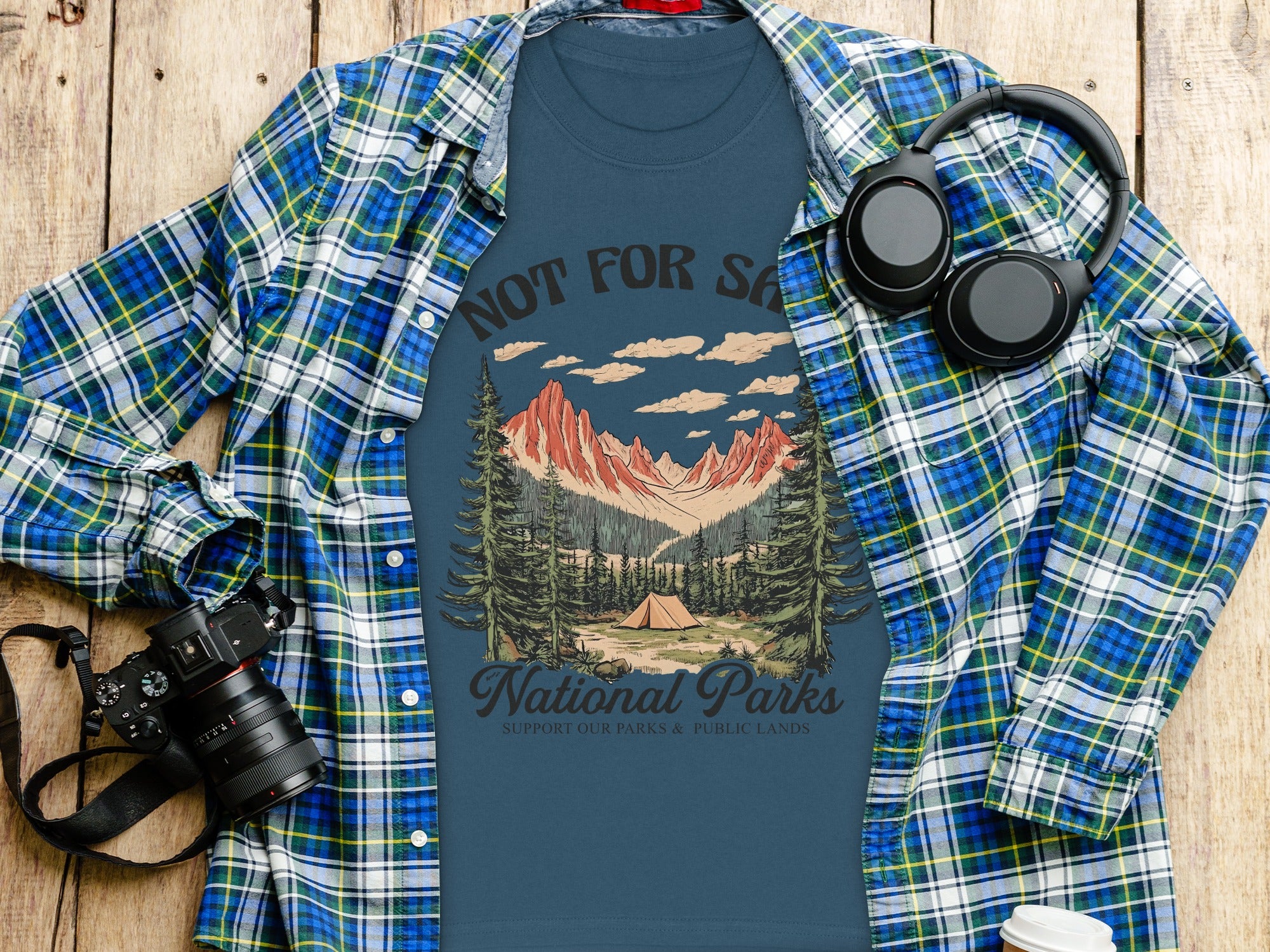 Blue t-shirt with "National Parks" graphic featuring mountains, tent, and trees.