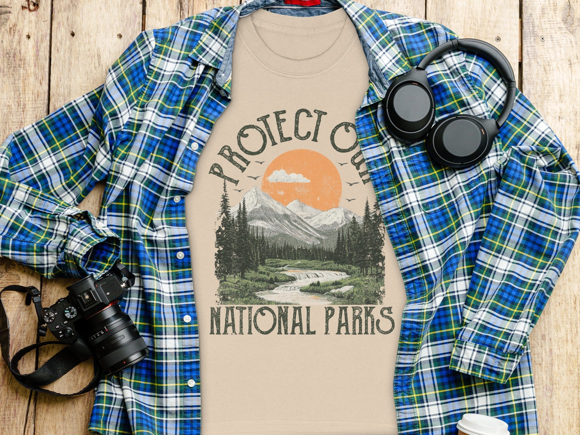 T-shirt with "Protect Our National Parks" graphic in a scenic mountain landscape.