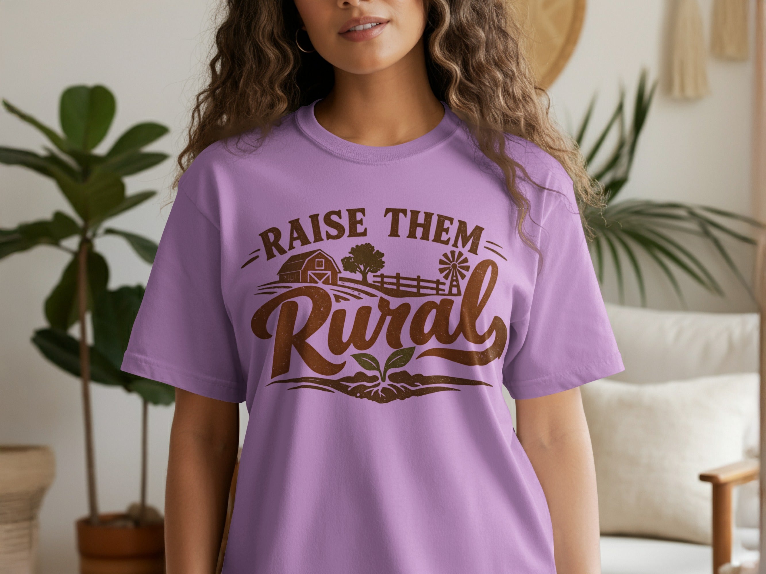 Purple t-shirt with "Raise them Rural" text and farm graphics.
