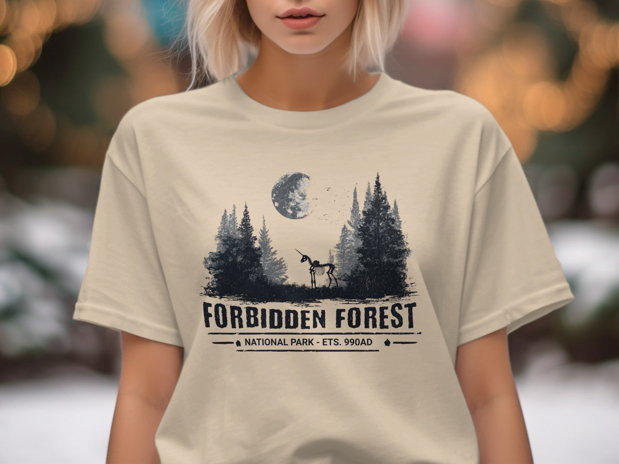 T-shirt graphic with skeleton unicorn, moon, trees, and text "Forbidden Forest".